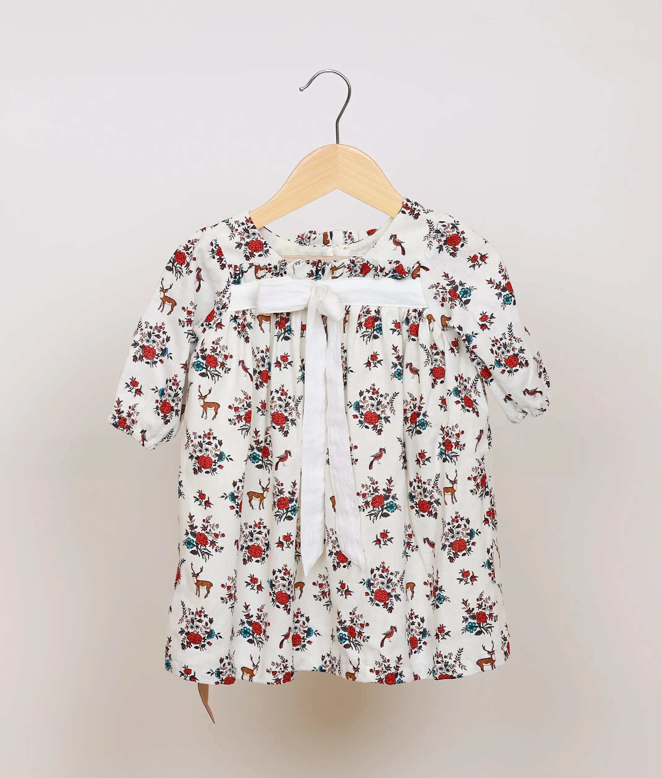 White floral printed cotton frock for baby girl, full front view showing flared skirt and puff sleeves.
