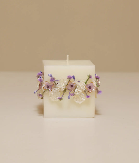 Decorative white baptism candle for baby featuring a large handcrafted silk rose and delicate lace ruffles