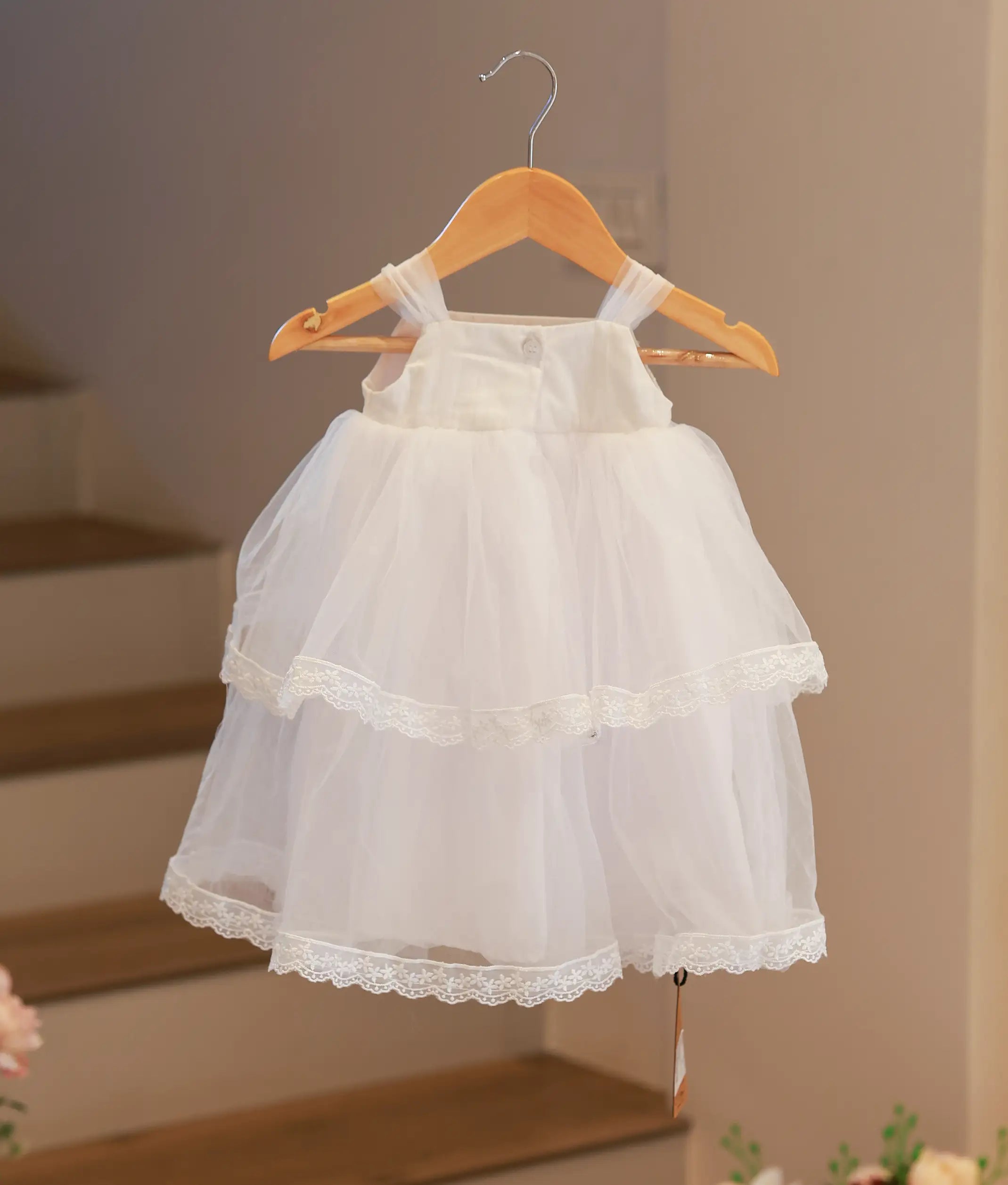Back view of the white floral baptism frock showing the elegant fastening and clean finish.