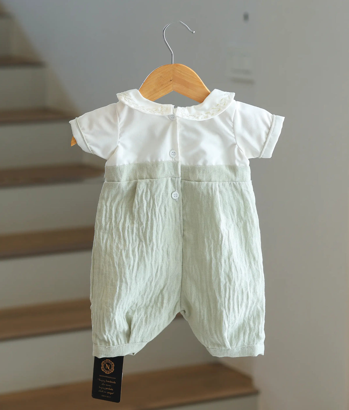 Back view of the baby boy baptism romper showing the button fasteners.