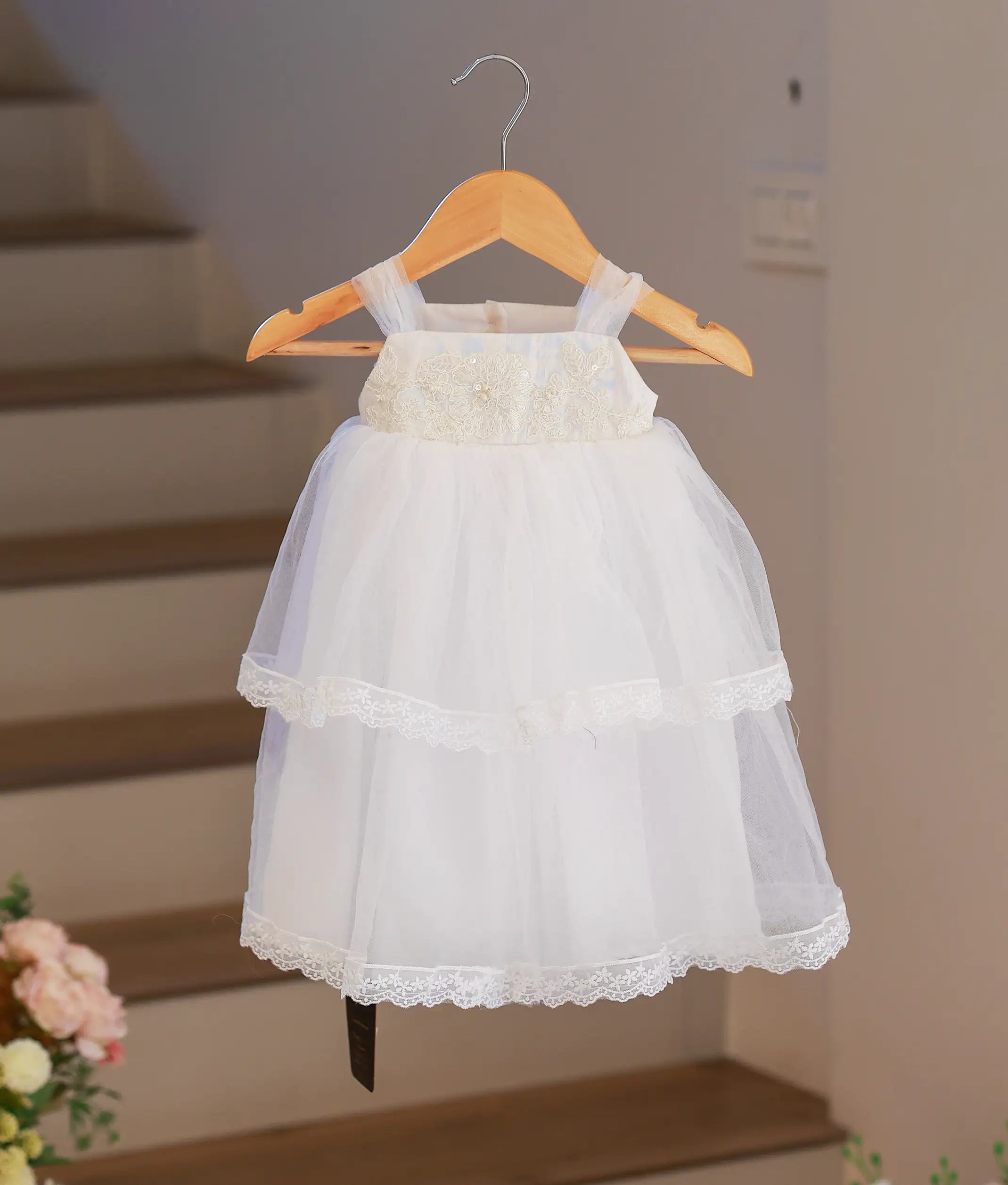 Full front view of a white baptism frock for baby girls featuring delicate floral embroidery on a premium tulle net skirt.