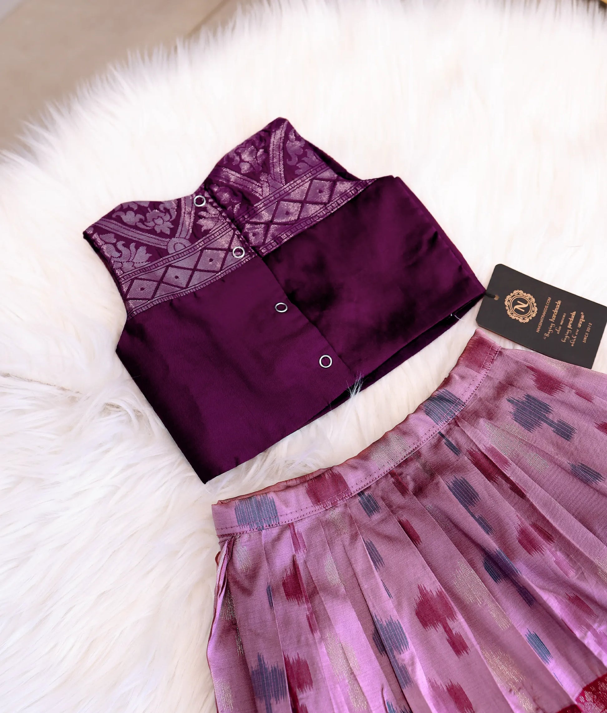 Back view of the wine silk top showing the neat press-button closures.