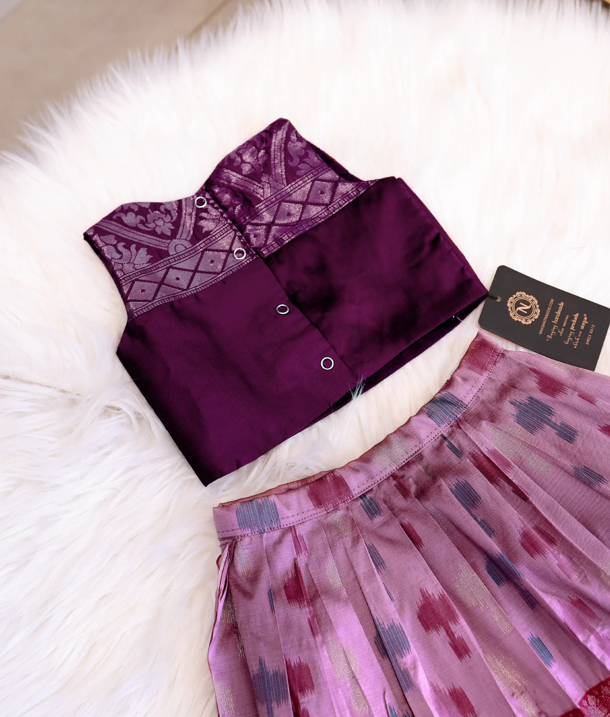 Back view of the wine silk top showing the neat press-button closures.