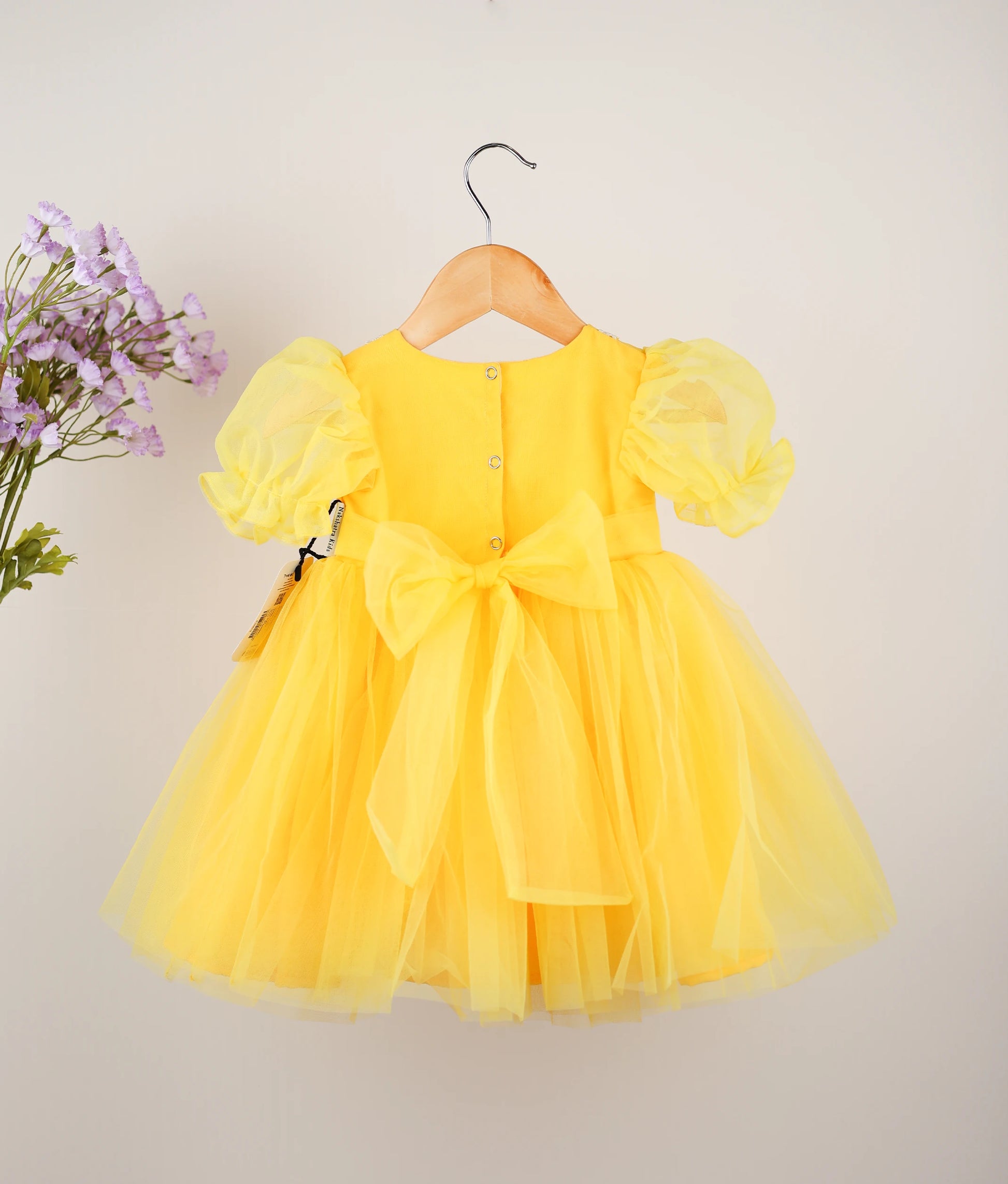 Back view of yellow embroidery casual frock against plain background