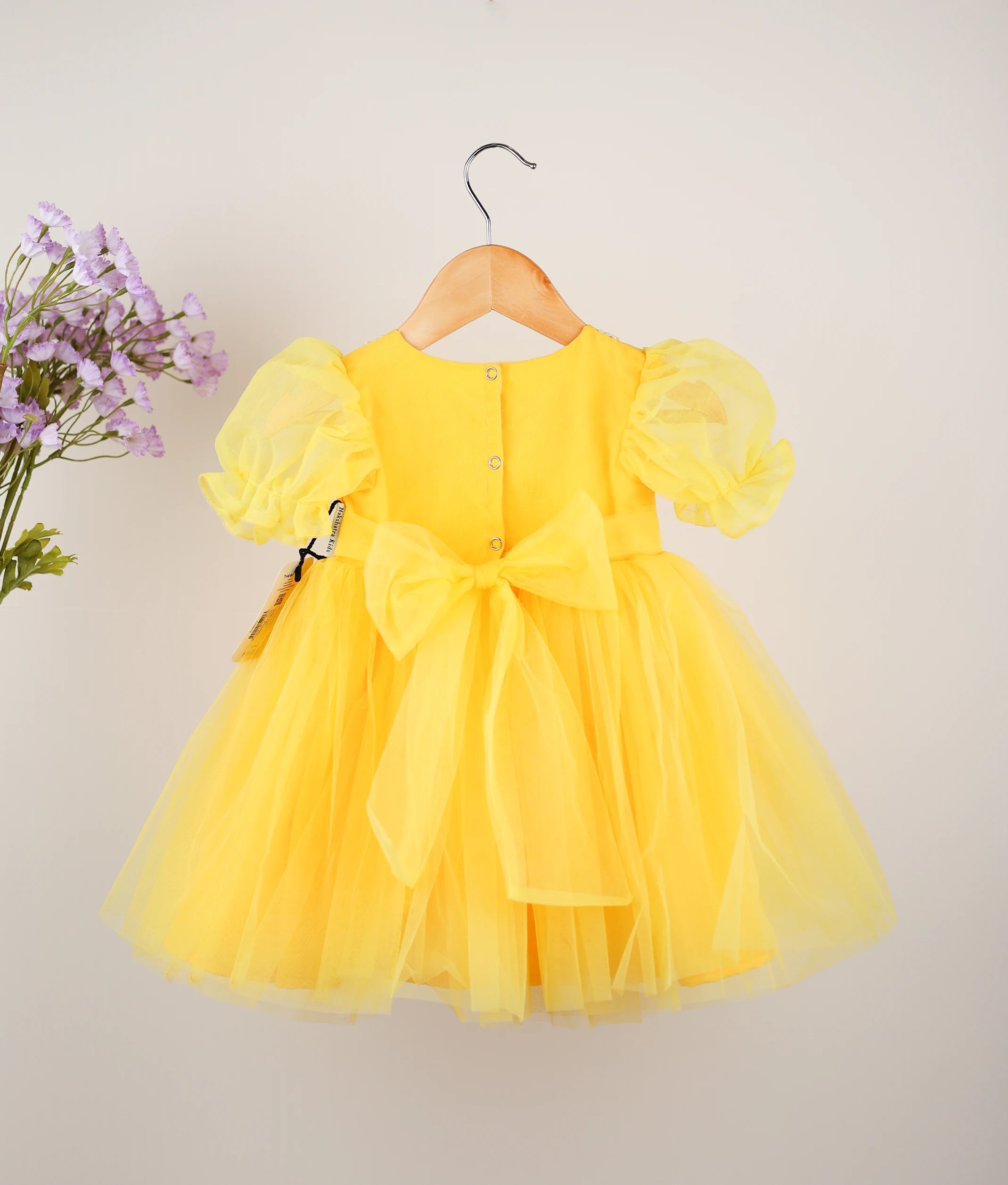 Back view of yellow embroidery casual frock against plain background