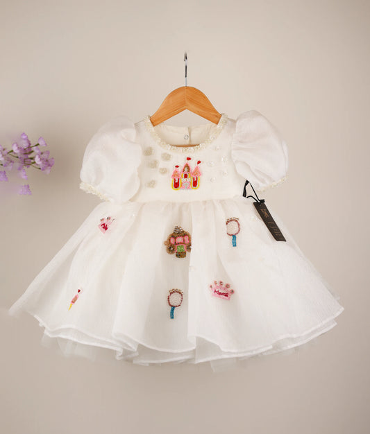 Front view of an off-white princess-themed dress against white background