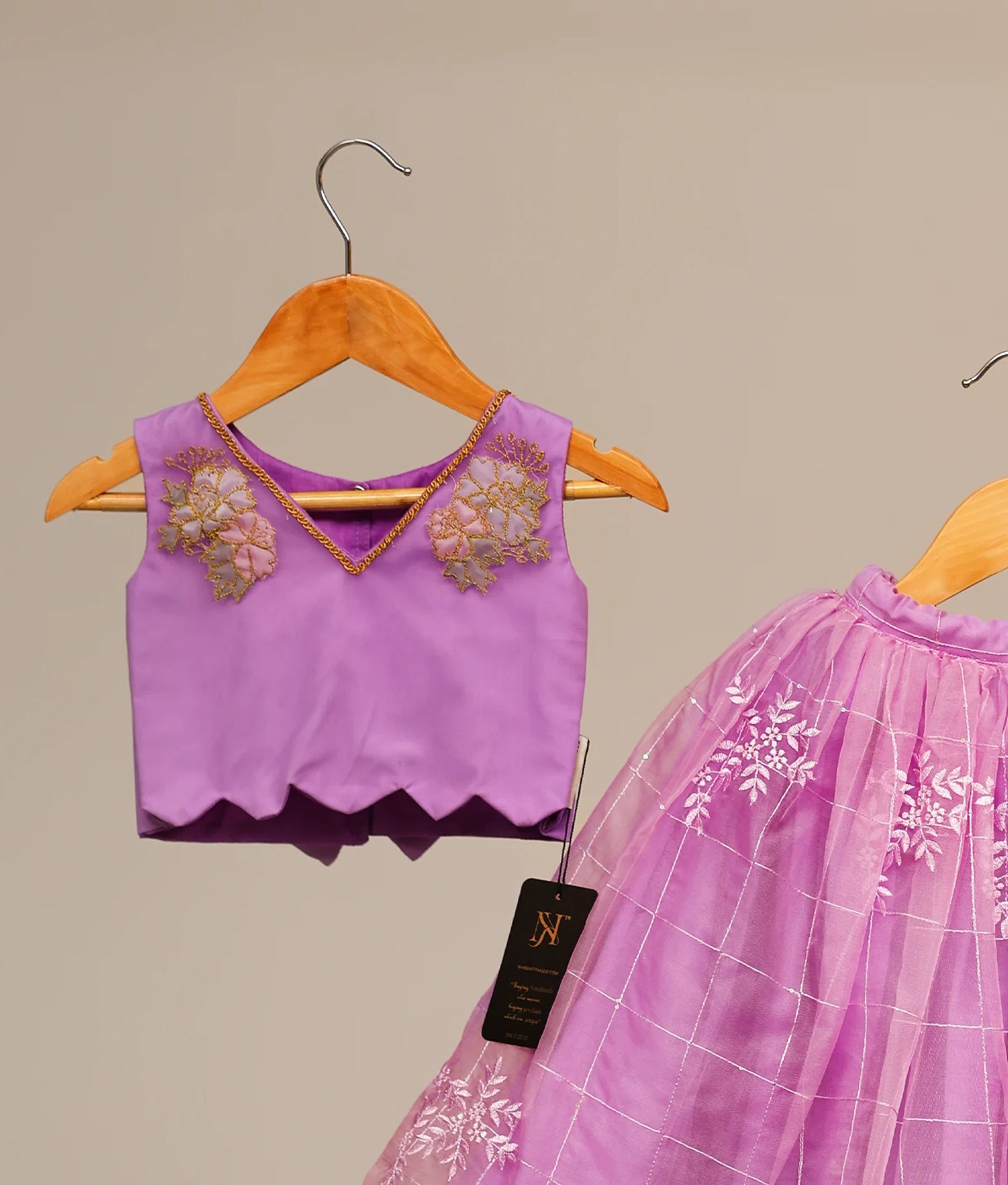 Lavender kids' lehenga choli short top and organza check skirt featuring white floral embroidery.