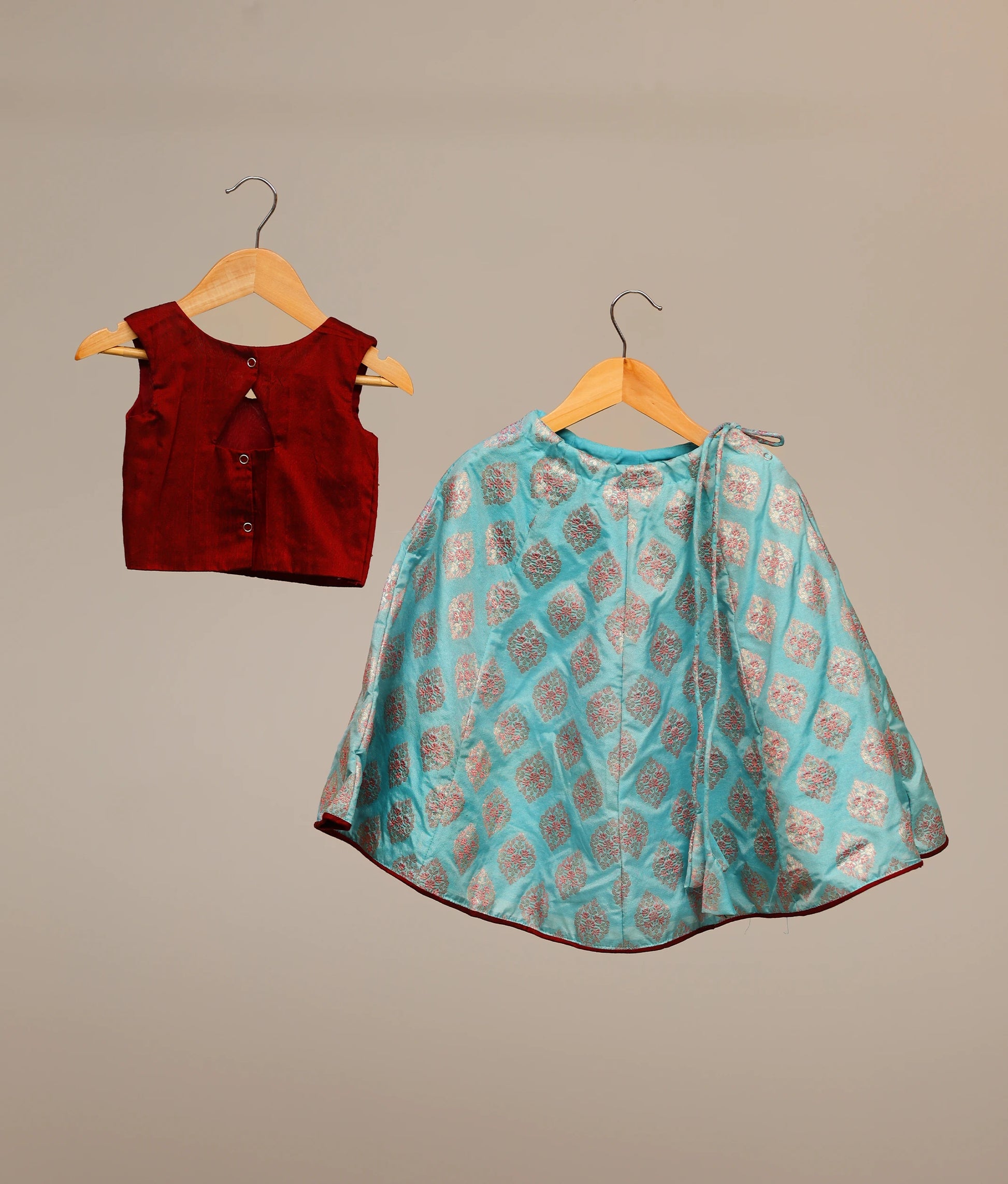 Back view of a maroon handworked top with banarasi peacock blue skirt 