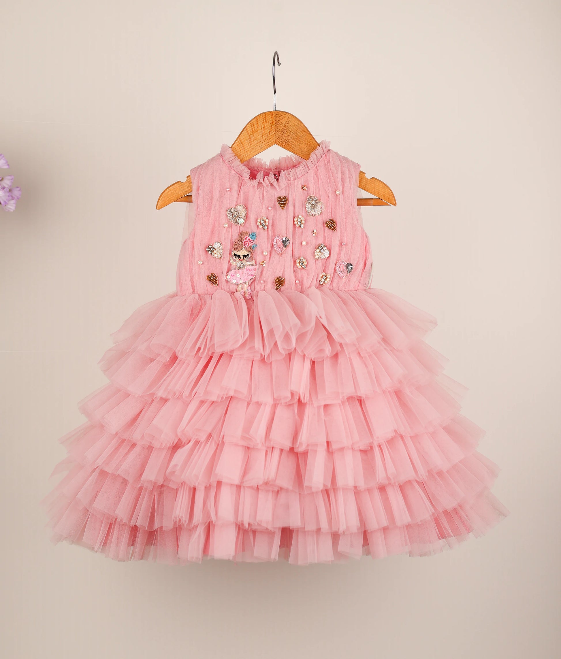 Front view of pink fairy-themed step birthday dress against plain background