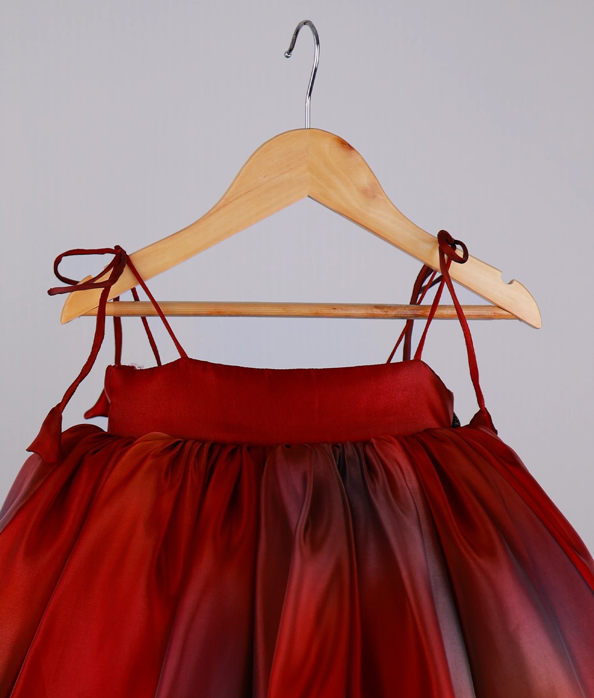 Close view of red multi-shade high-low birthday frock for baby girl 