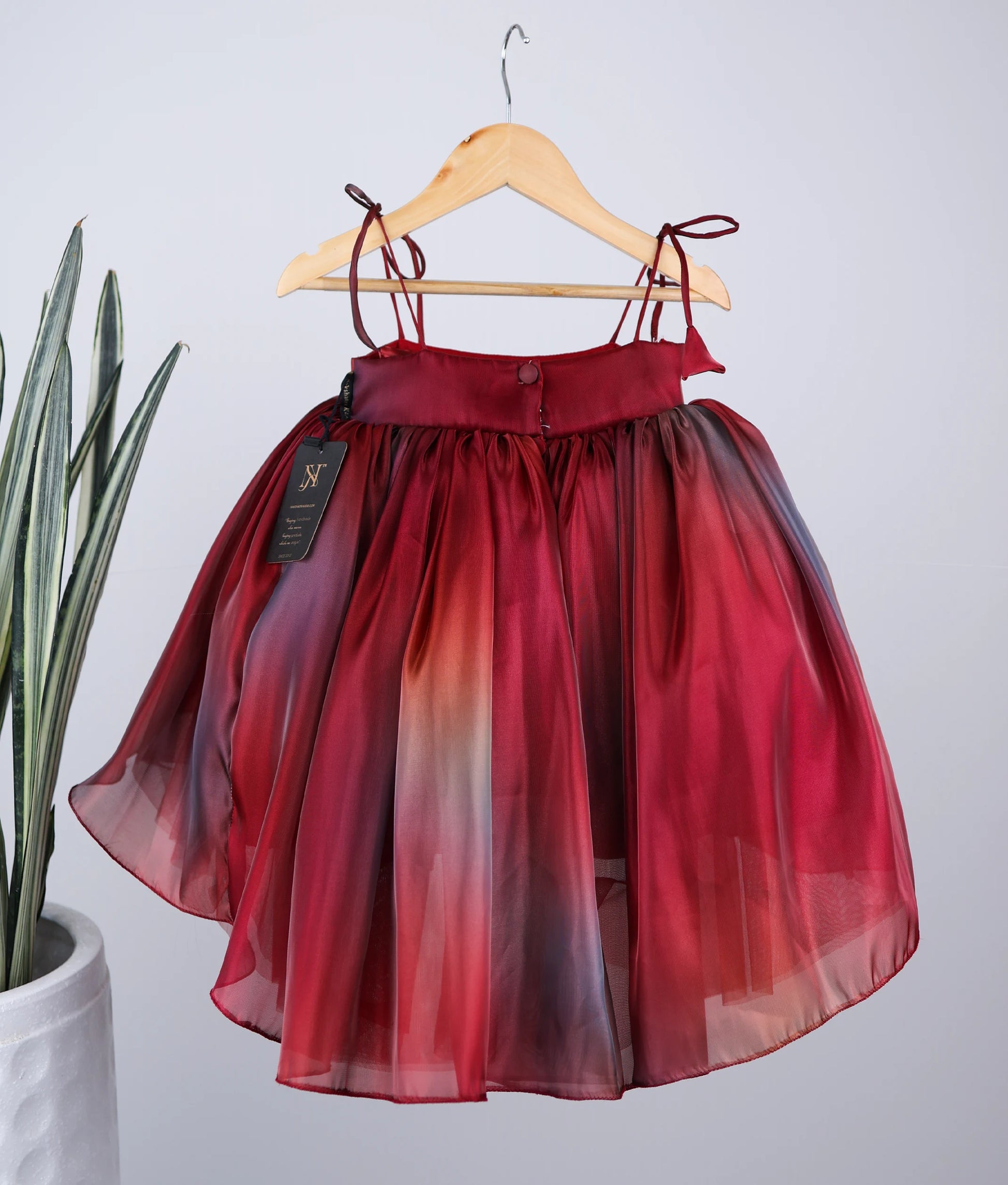 Back view of red multi-shade high-low birthday frock for baby girl 