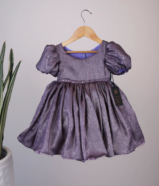 Front view of an handworked milan foil frock against white background