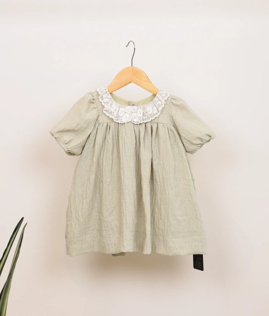 Front view of a pastel green linen christmas frock.