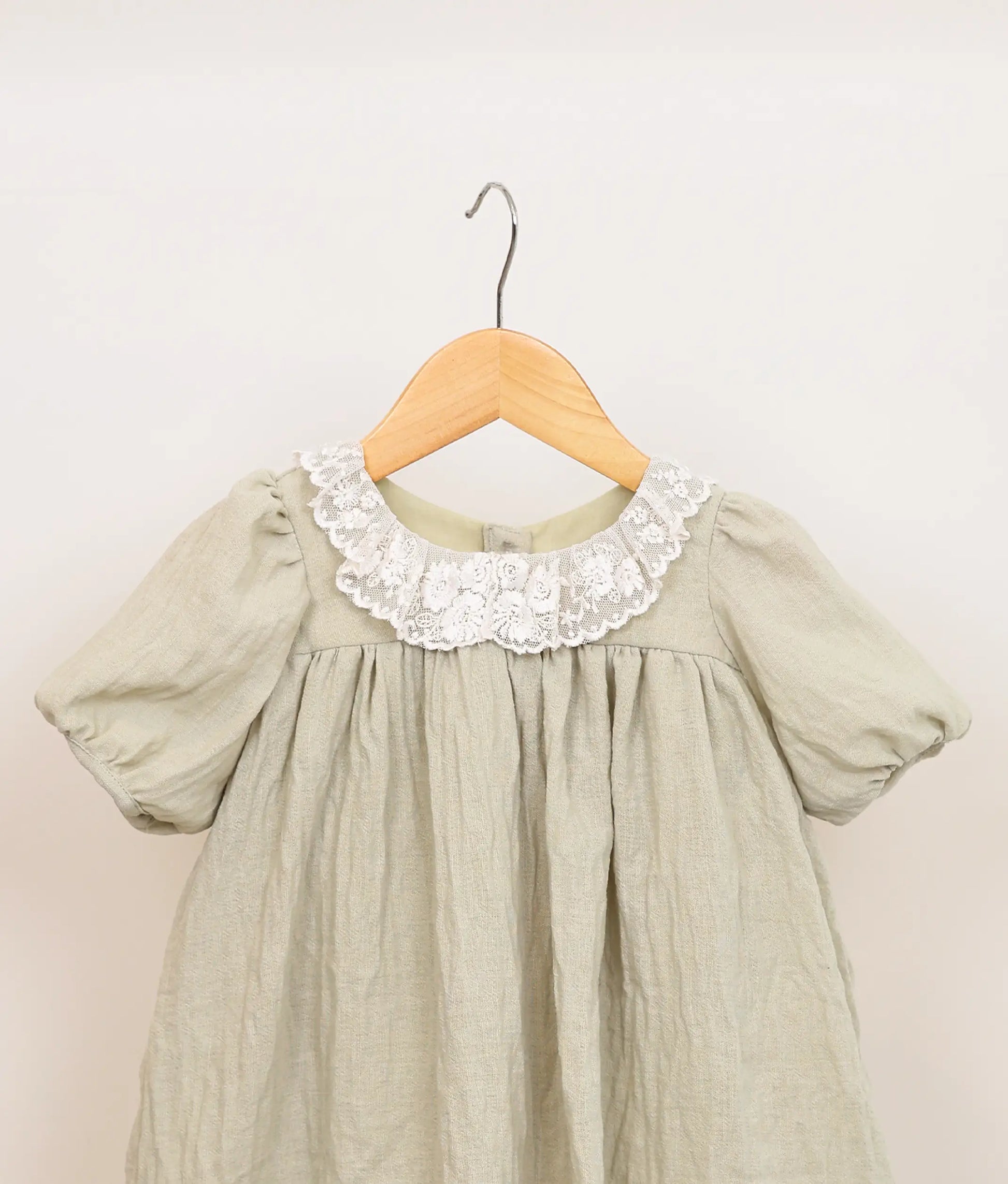 Close view of a pastel green linen christmas frock.