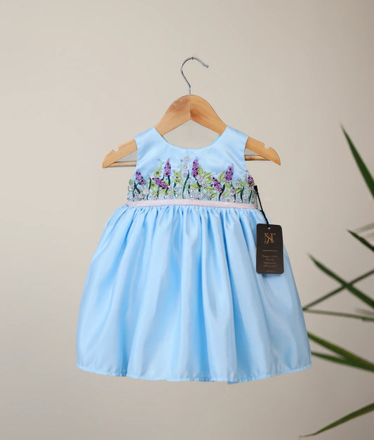 Front view of blue bridal satin organza flower-themed dress with white background