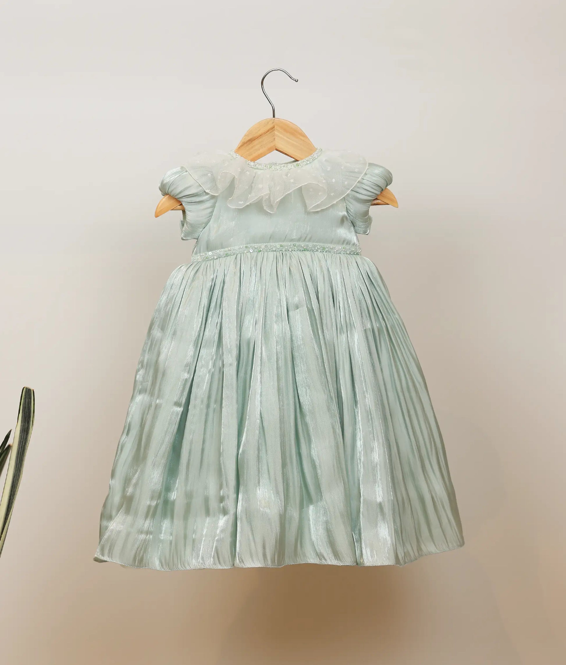 Front view of pastel green laser organza birthday gown
