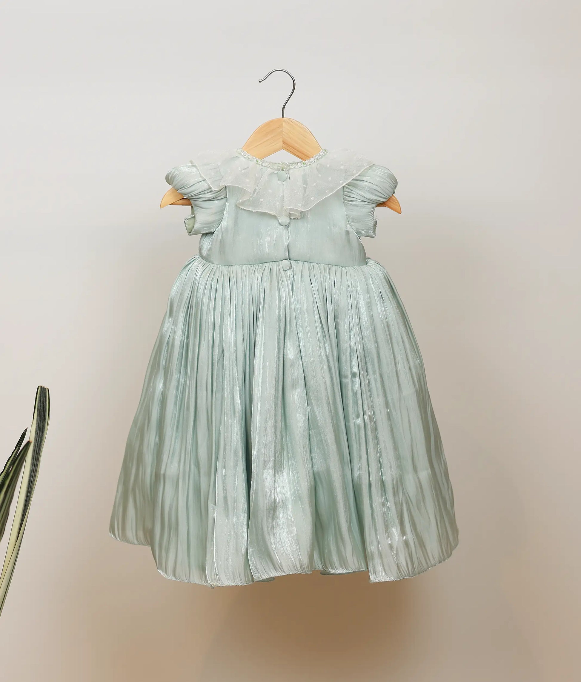 Close view of pastel green laser organza birthday gown