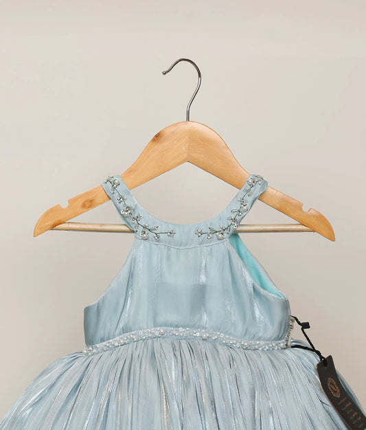 Close view of powder blue lacer organza handworked birthday frock against plain background