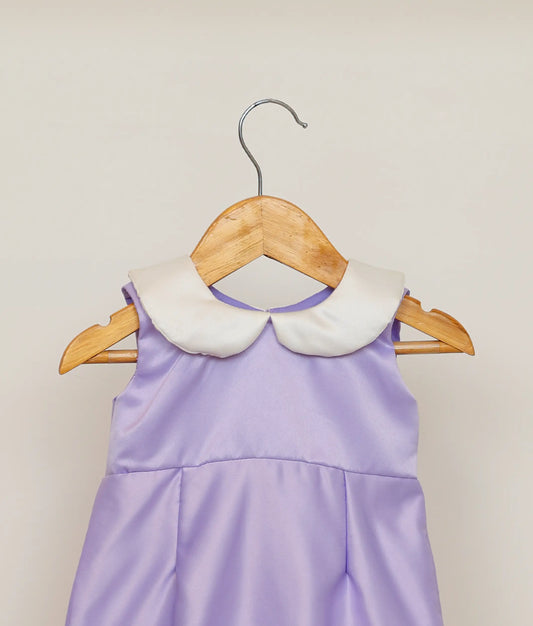Close view of an lavender fish-cut birthday frock against white background 