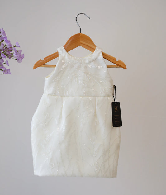 Front view of an off-white work material fish-cut baptism frock against plain background