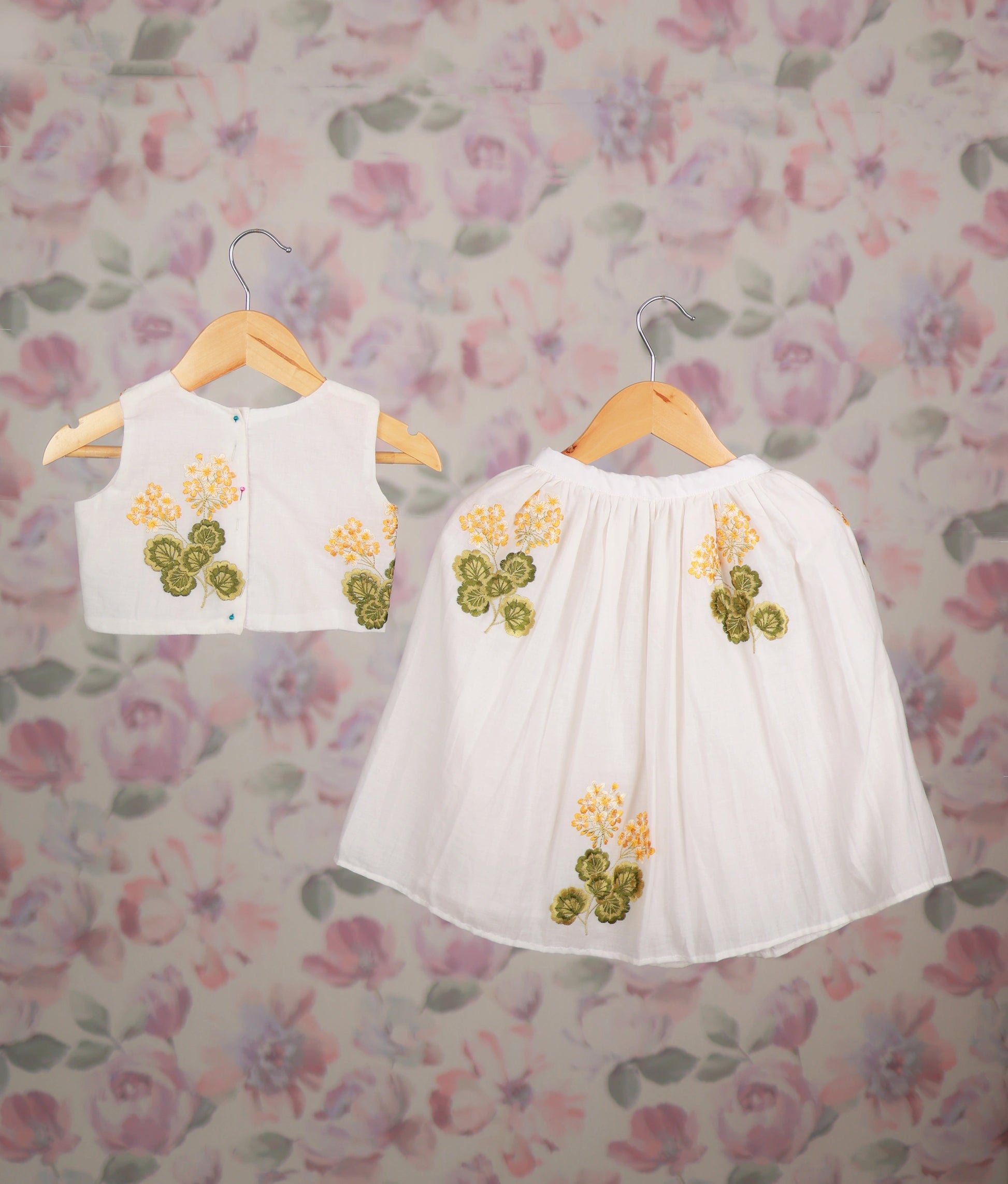White baby girl skirt set with yellow floral embroidery and Peter Pan collar,
top ethnic wear.