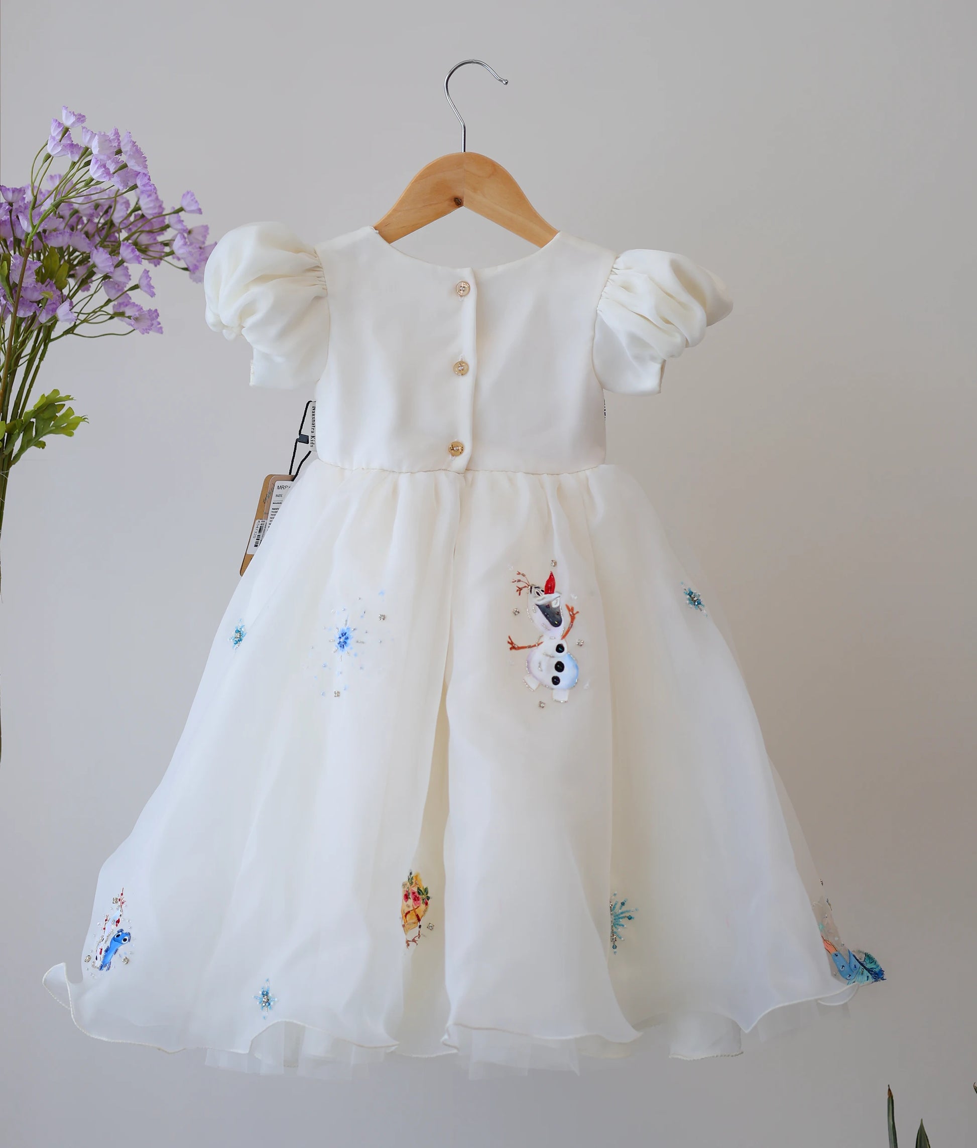 Front view of an off-white, plain organza disney princess themed birthday gown. 