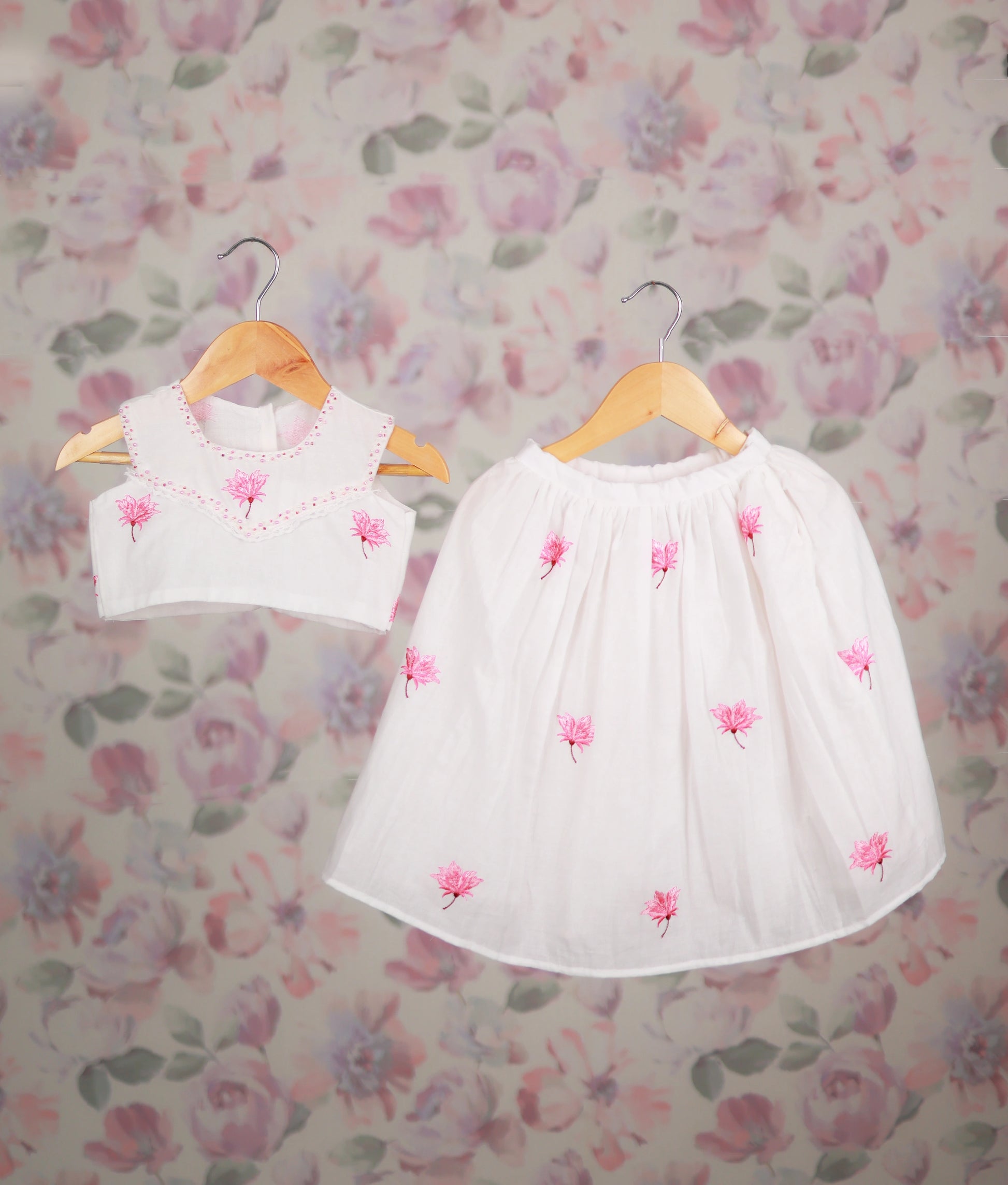 White baby girl skirt set with pink floral embroidery top, ethnic outfit.