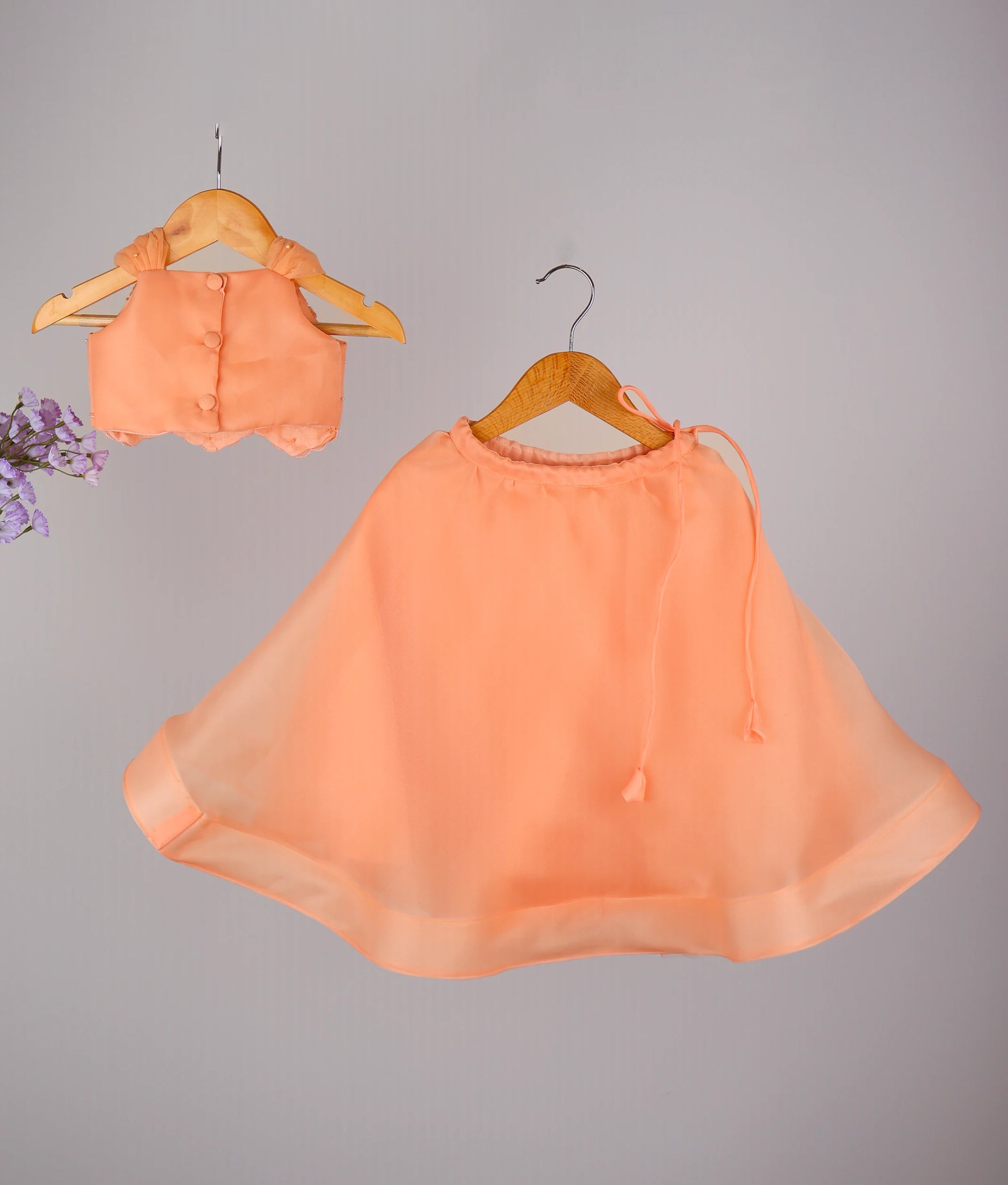 Peach designer kids lehenga choli set with handworked top and flared skirt, perfect for parties.