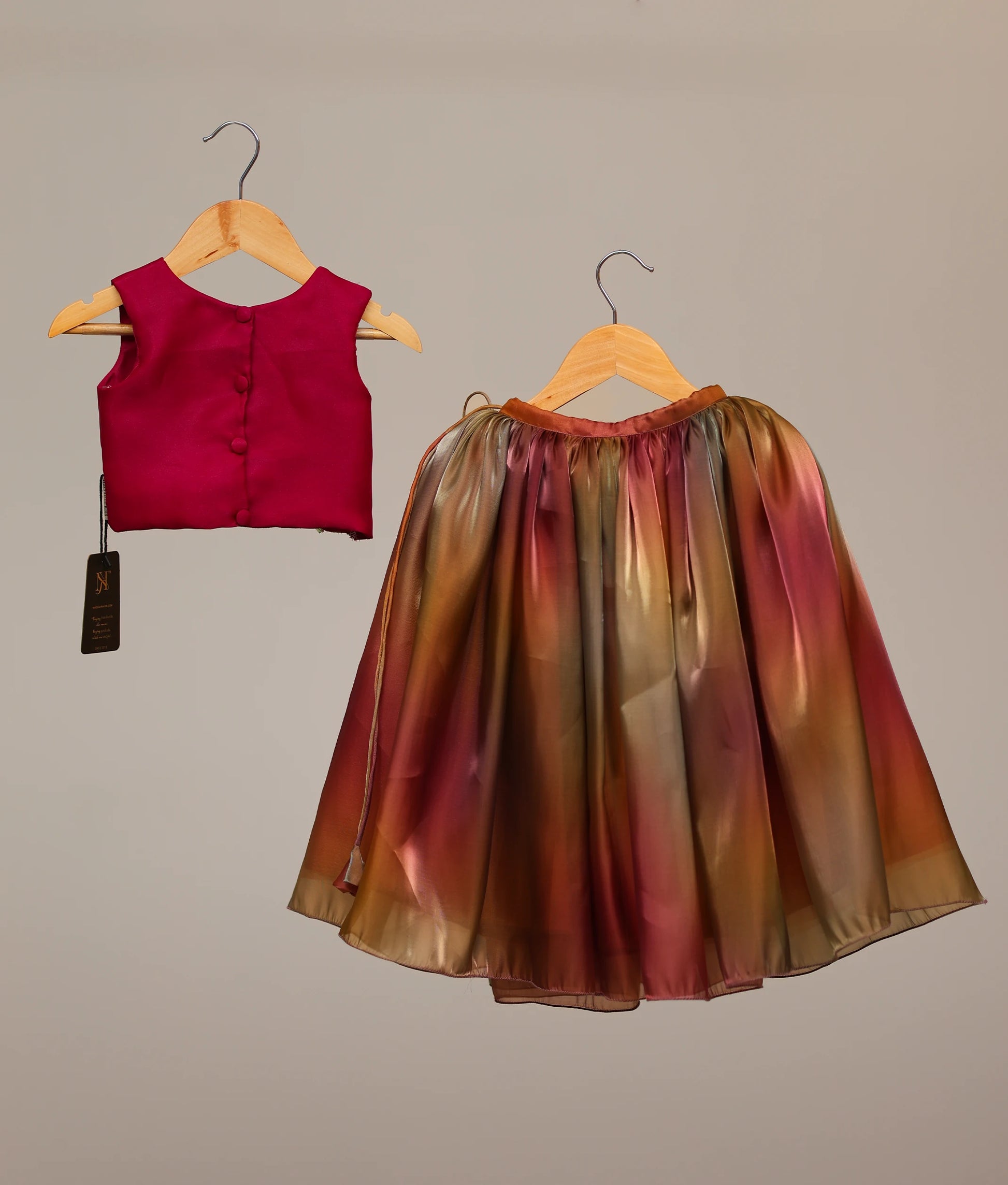 Back view of a rani pink lehenga for kids with floral handwork. Multicolored skirt for girls.