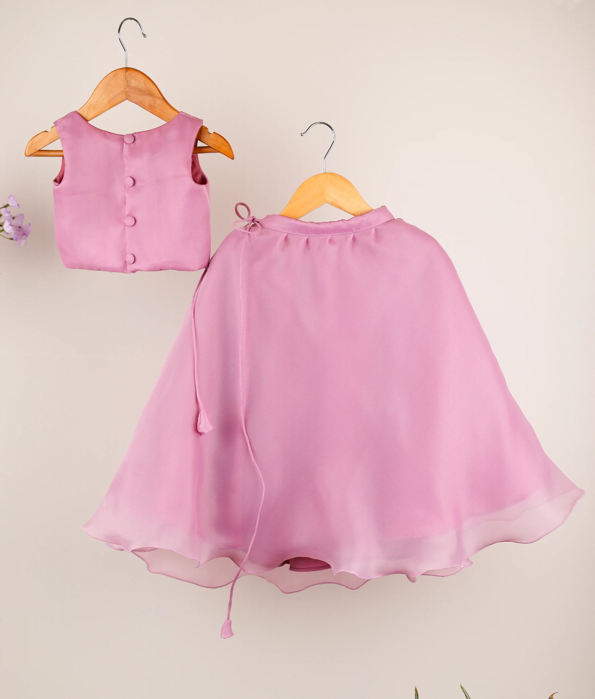 Back view of an pastel Lavender Sleeveless Handworked short top against plain background