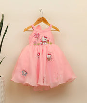 Front view of embroidery kitty-themed dress for baby girl against plain background