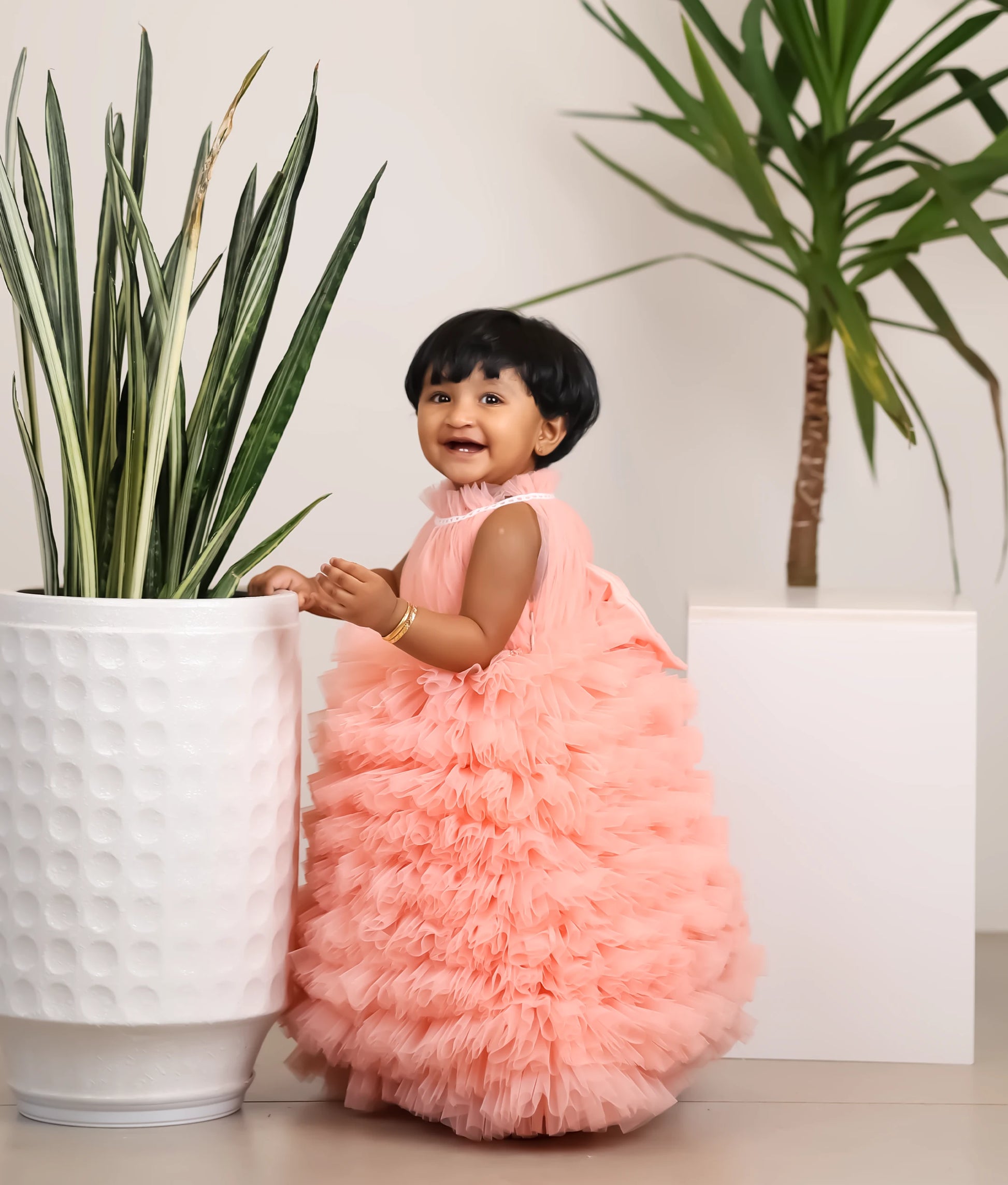 side view of powder peach halter-neck handworked birthday gown