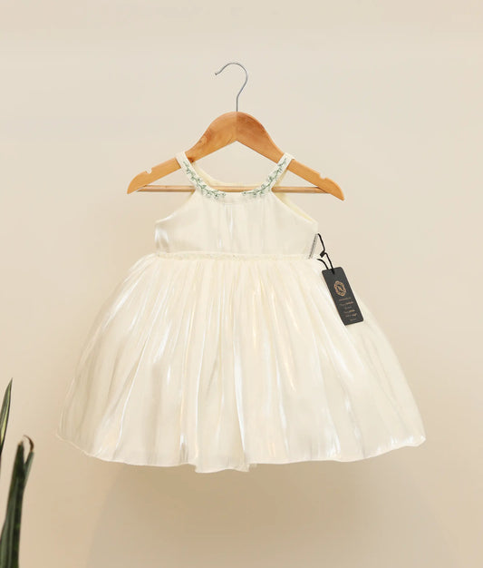Front view of an off-white lacer organza handworked baptism frock against plain background 