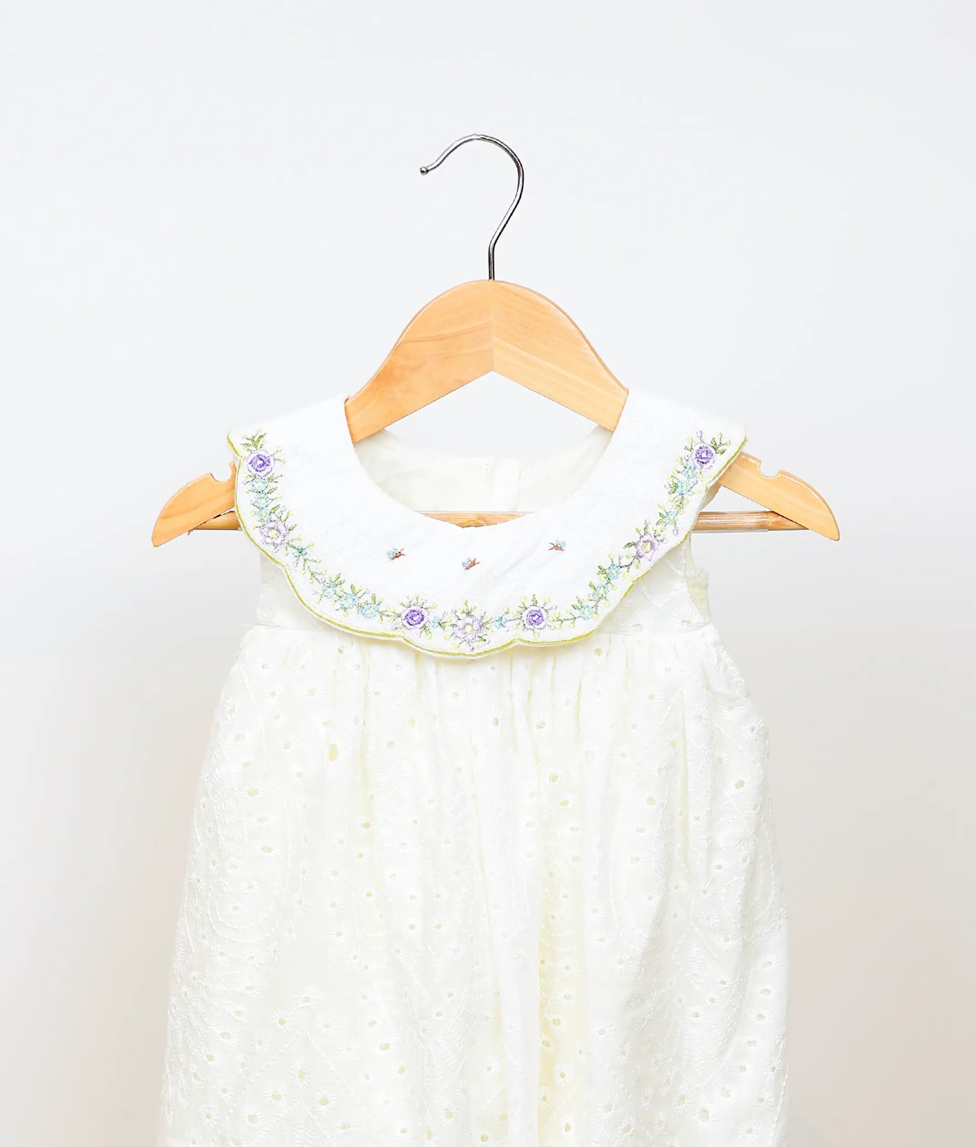 Close view of an off-white hacoba a-line christmas frock against plain background