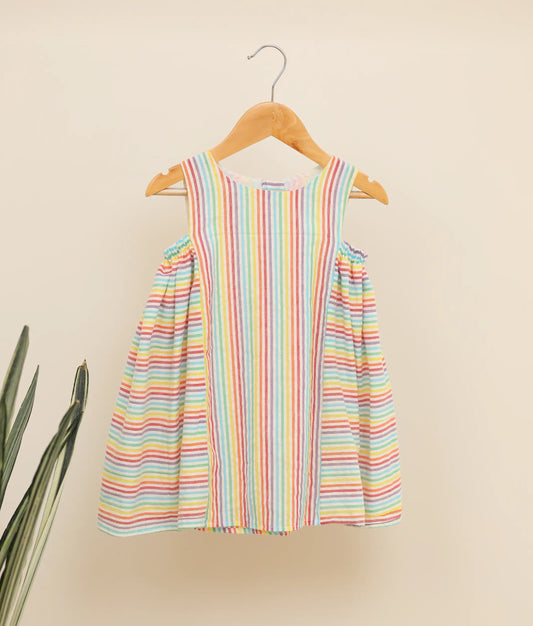 Front view of a multi-lined cotton Christmas frock against plain background