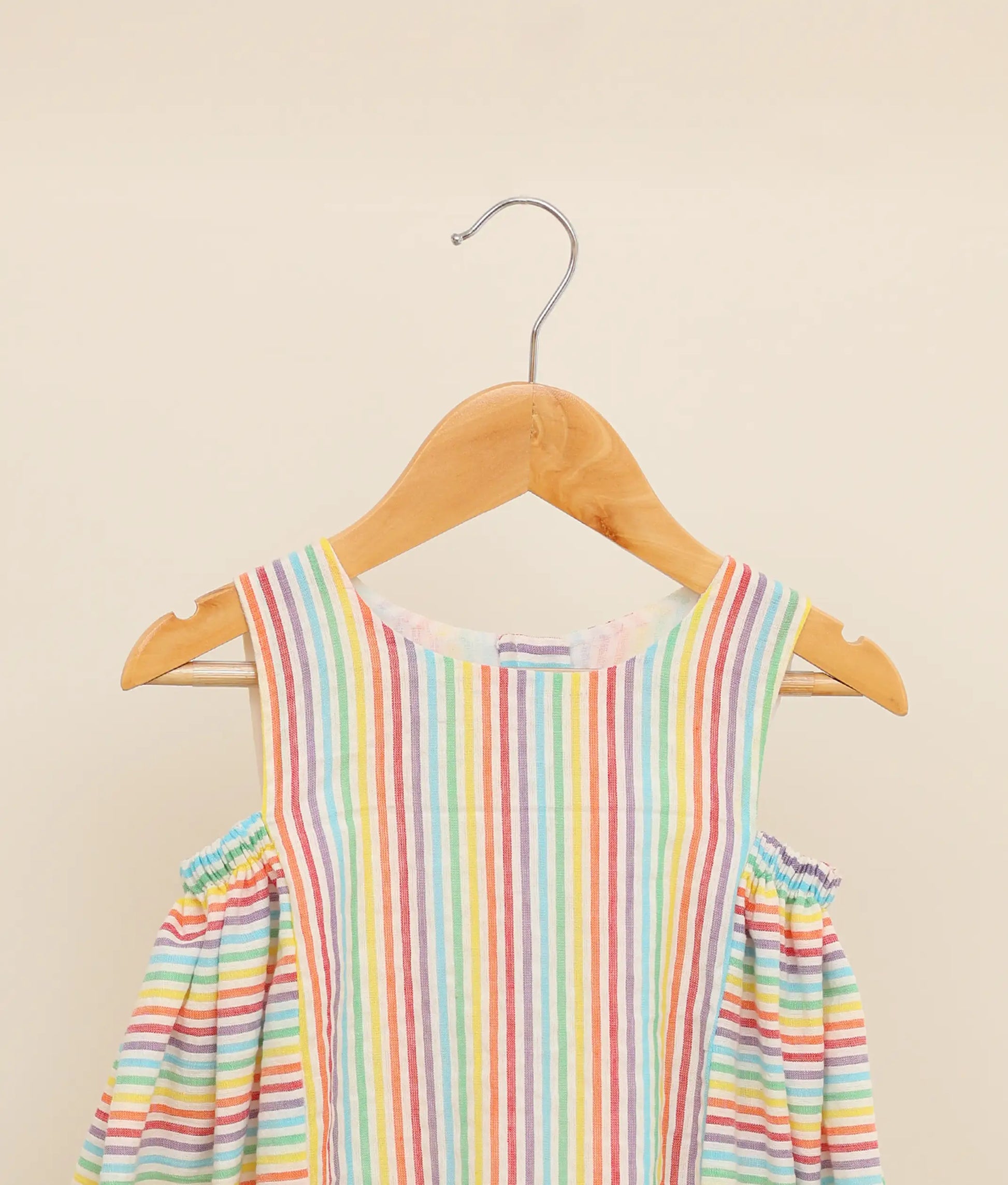 Close view of a multi-lined cotton Christmas frock against plain background