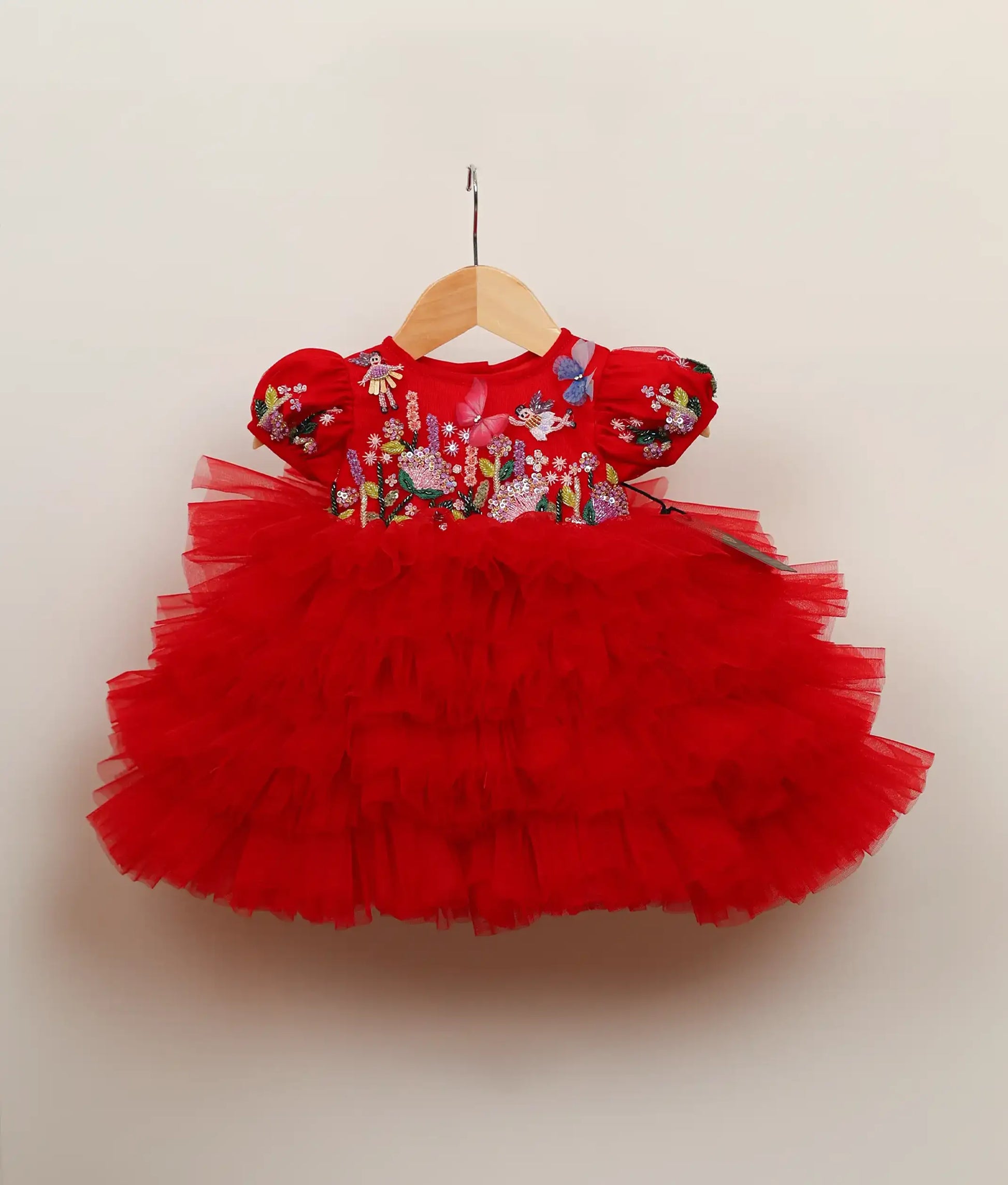 Front view of red tulle net butterfly-themed step birthday dress against plain background