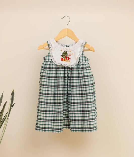 Front view of a green-check-embroidered cotton frock against plain background