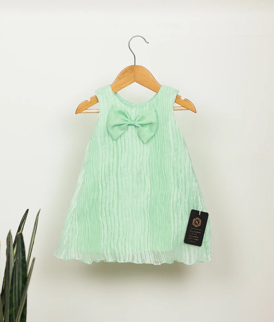 Front view of sea green tuck organza christmas frock against plain background