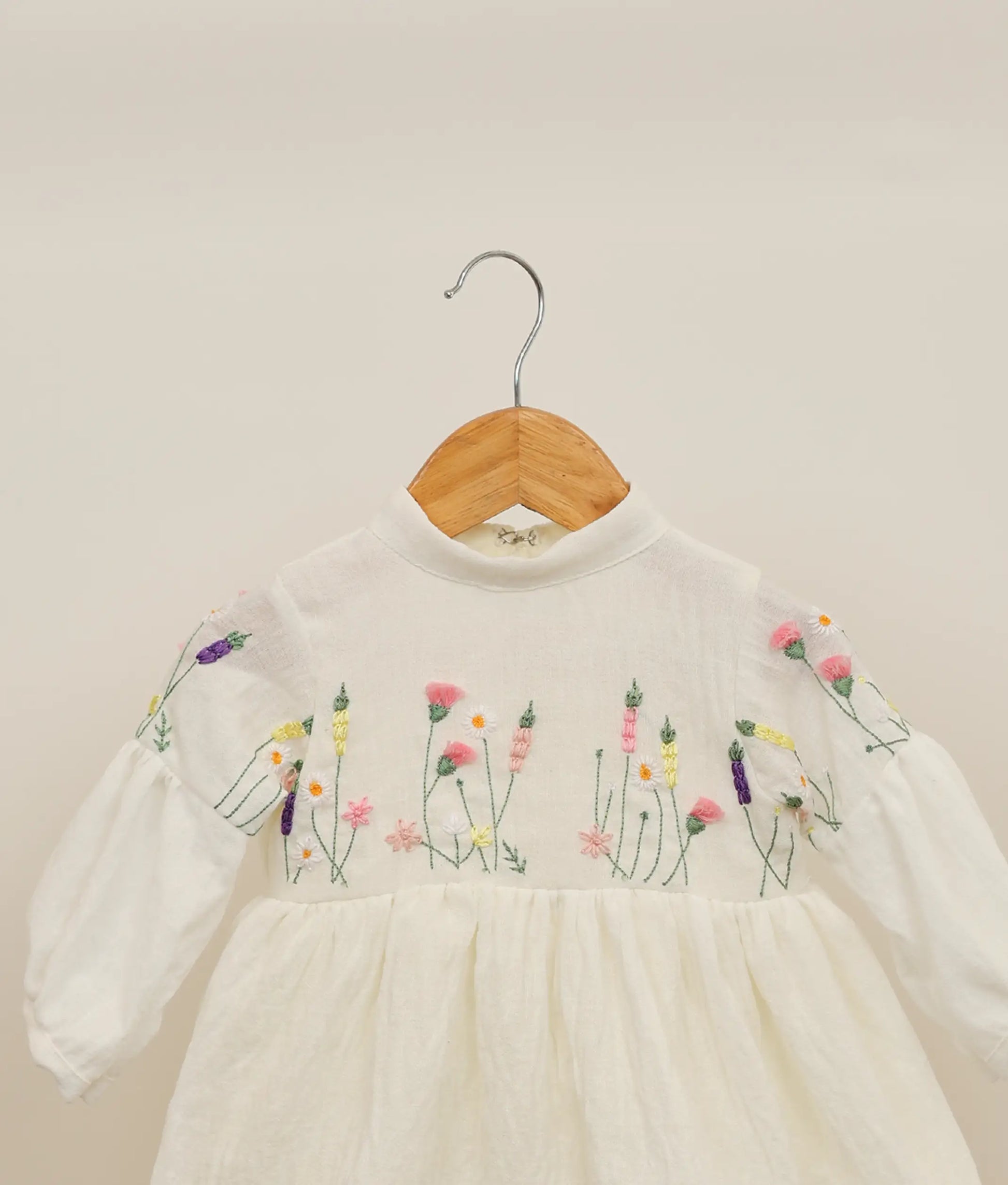 Close view of a linen cotton floral embroidery casual frock against plain background 