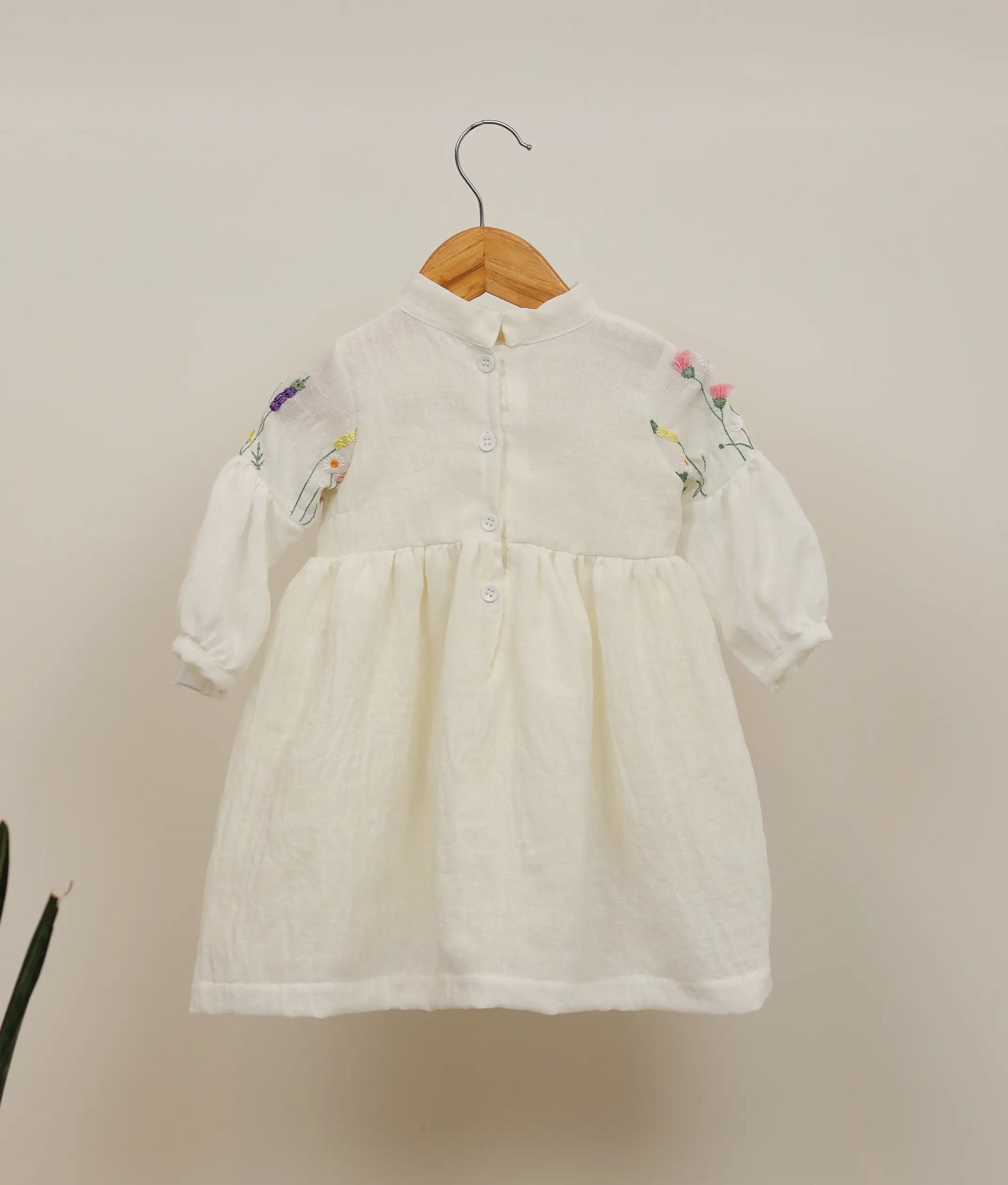 Back view of a linen cotton floral embroidery casual frock against plain background 