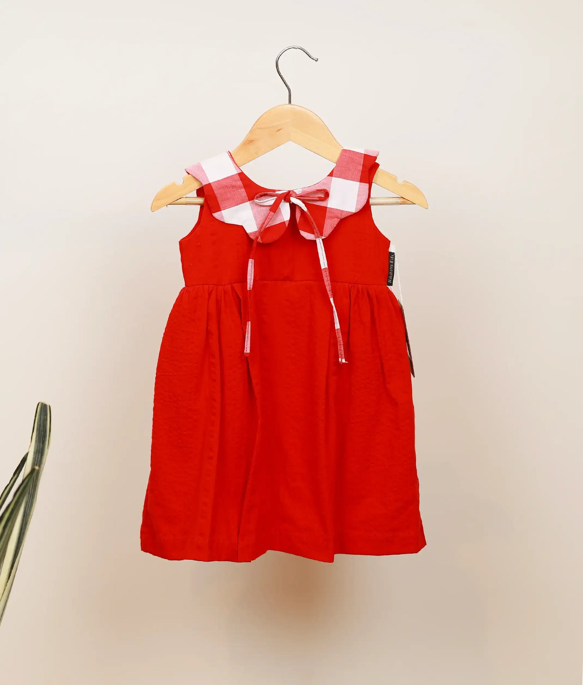 Front view of red cotton christmas frock for baby girl