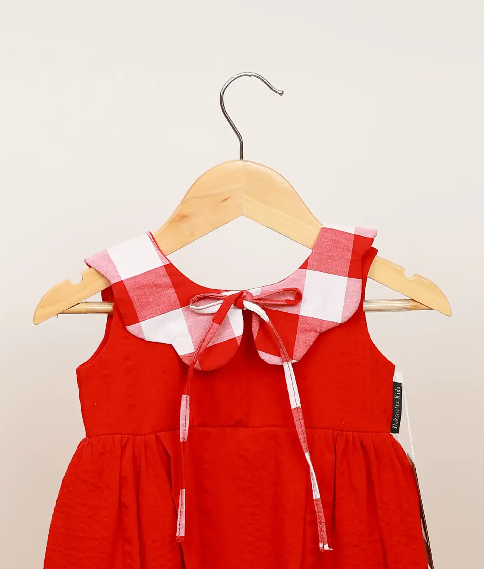 Close view of red cotton christmas frock for baby girl