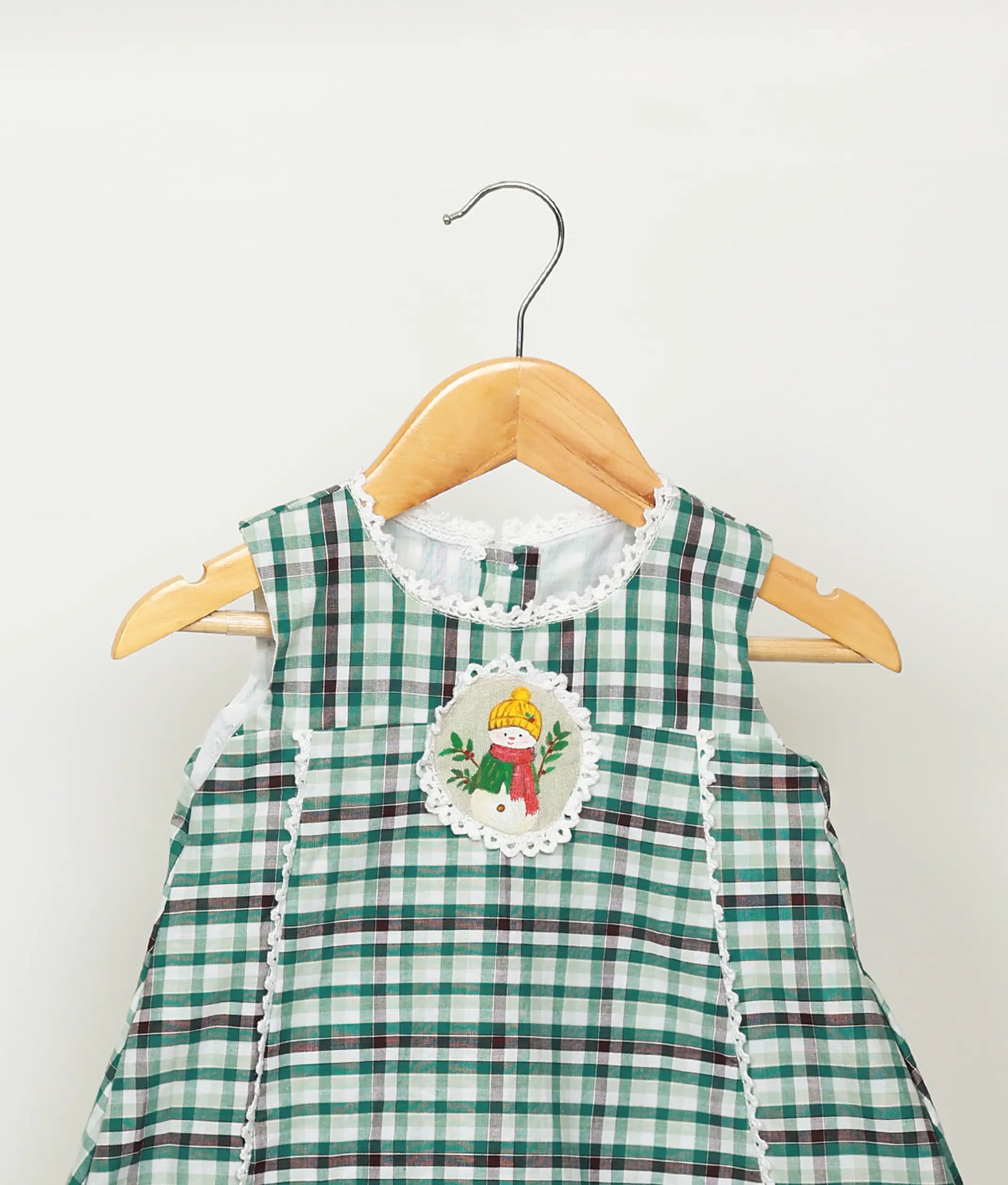 Close view of green check cotton embroidery Christmas frock  