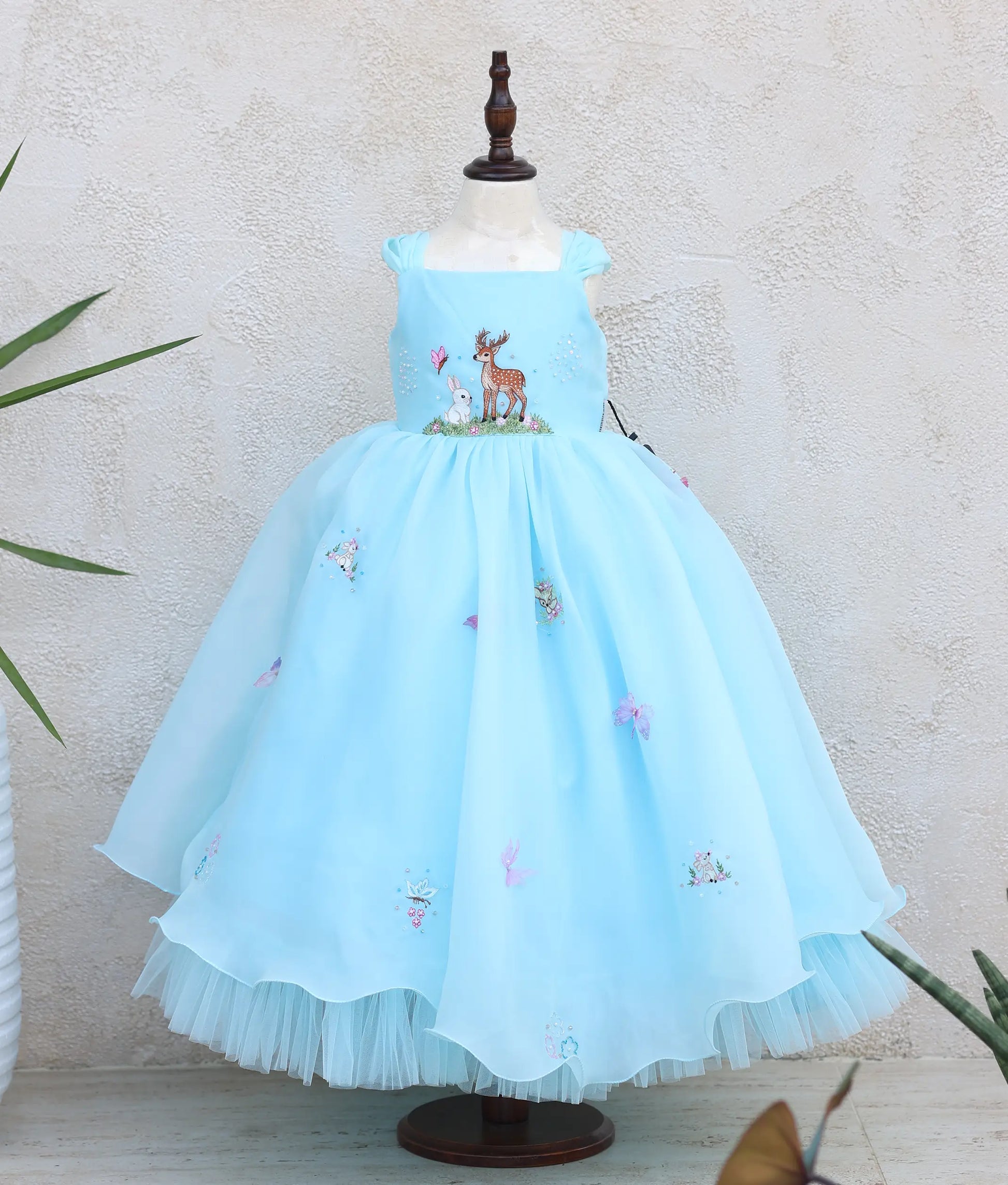 front view of plain organza deer- and rabbit-themed birthday gown