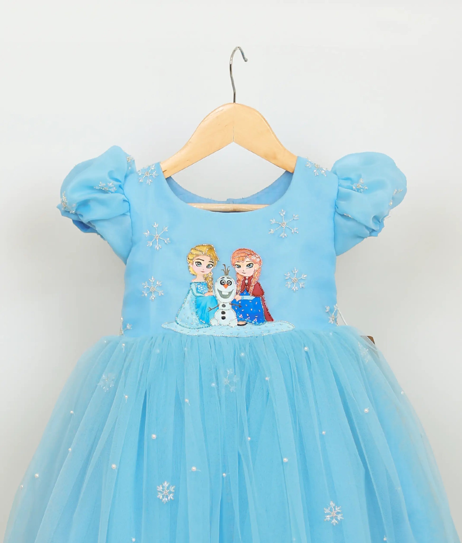 Close view of blue tulle net hand-painted frozen-theme birthday gown 