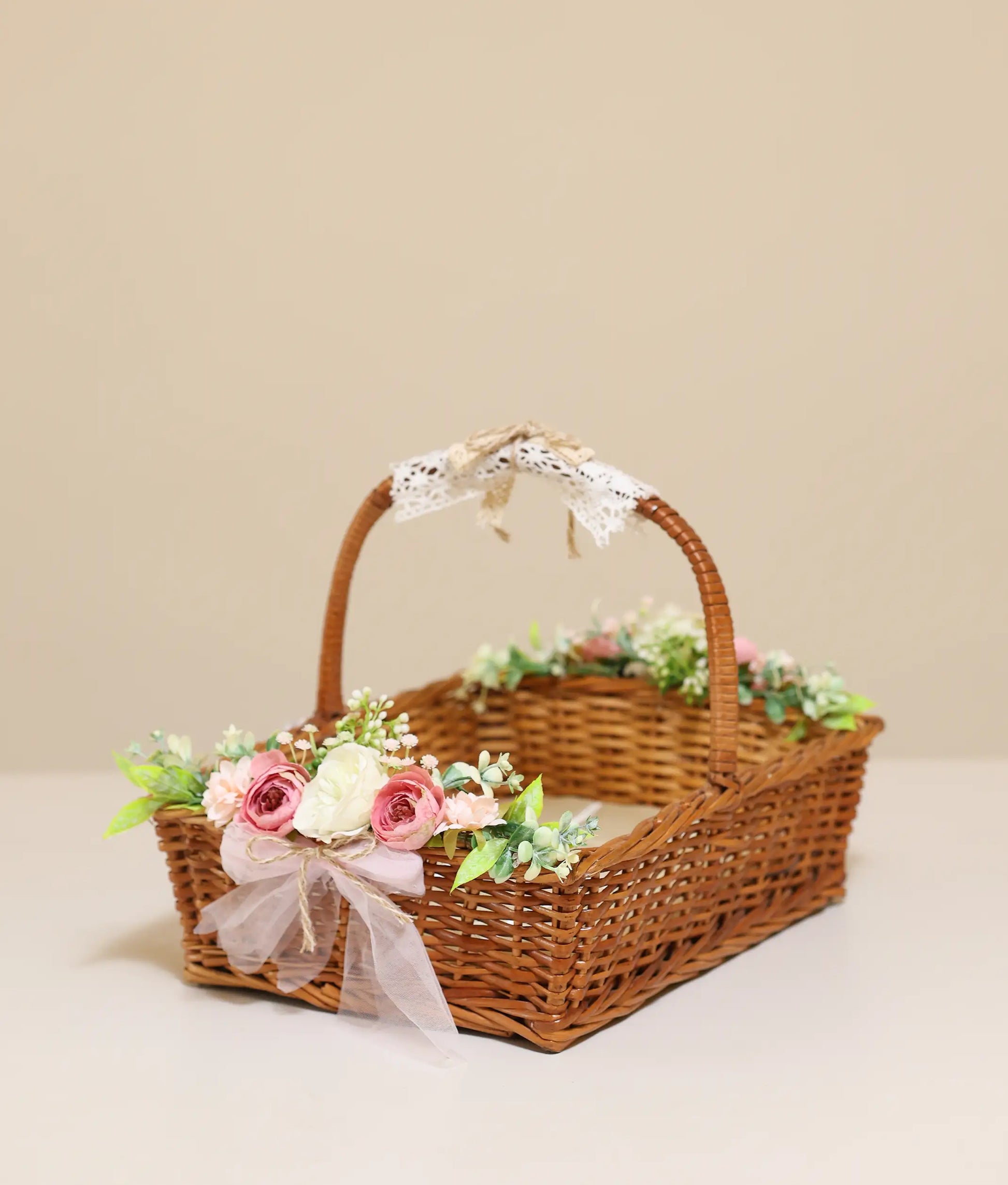 Floral wicker basket for baptism against plain background
