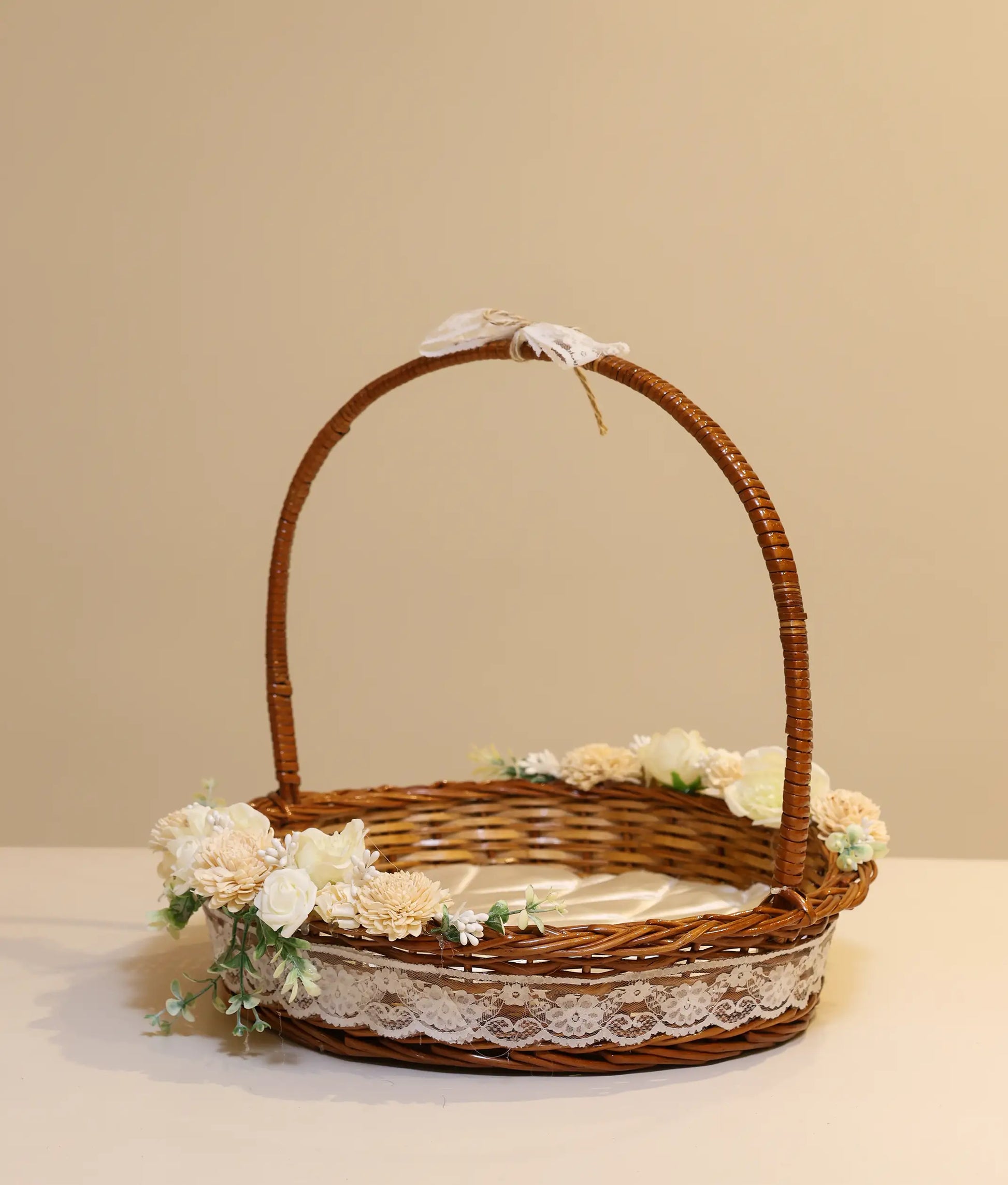 Off-white decorative flower wicker baptism basket against plain background background