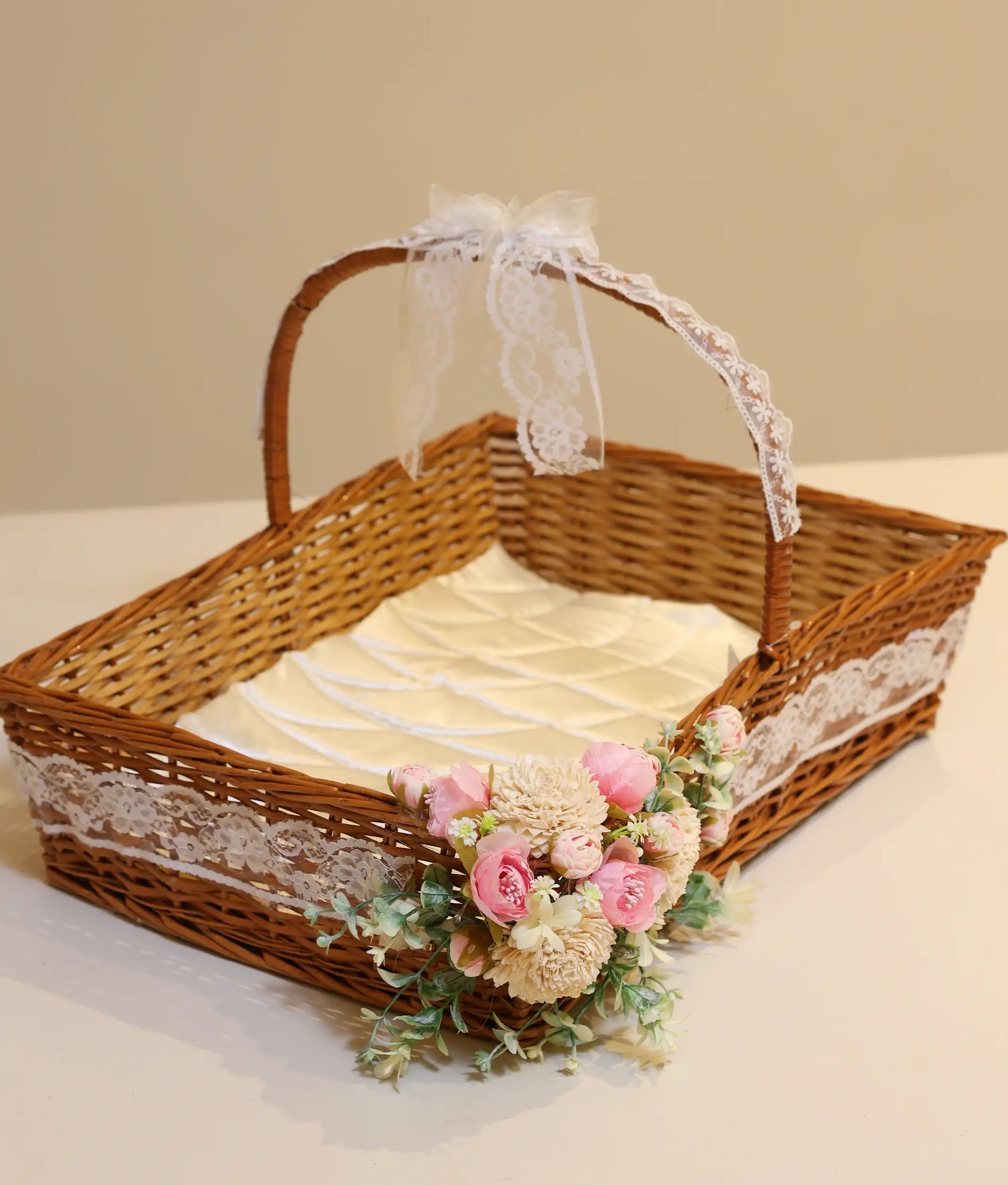 Close view of an off-white and pink wicker flower baptism basket for baby christening ,against white background
