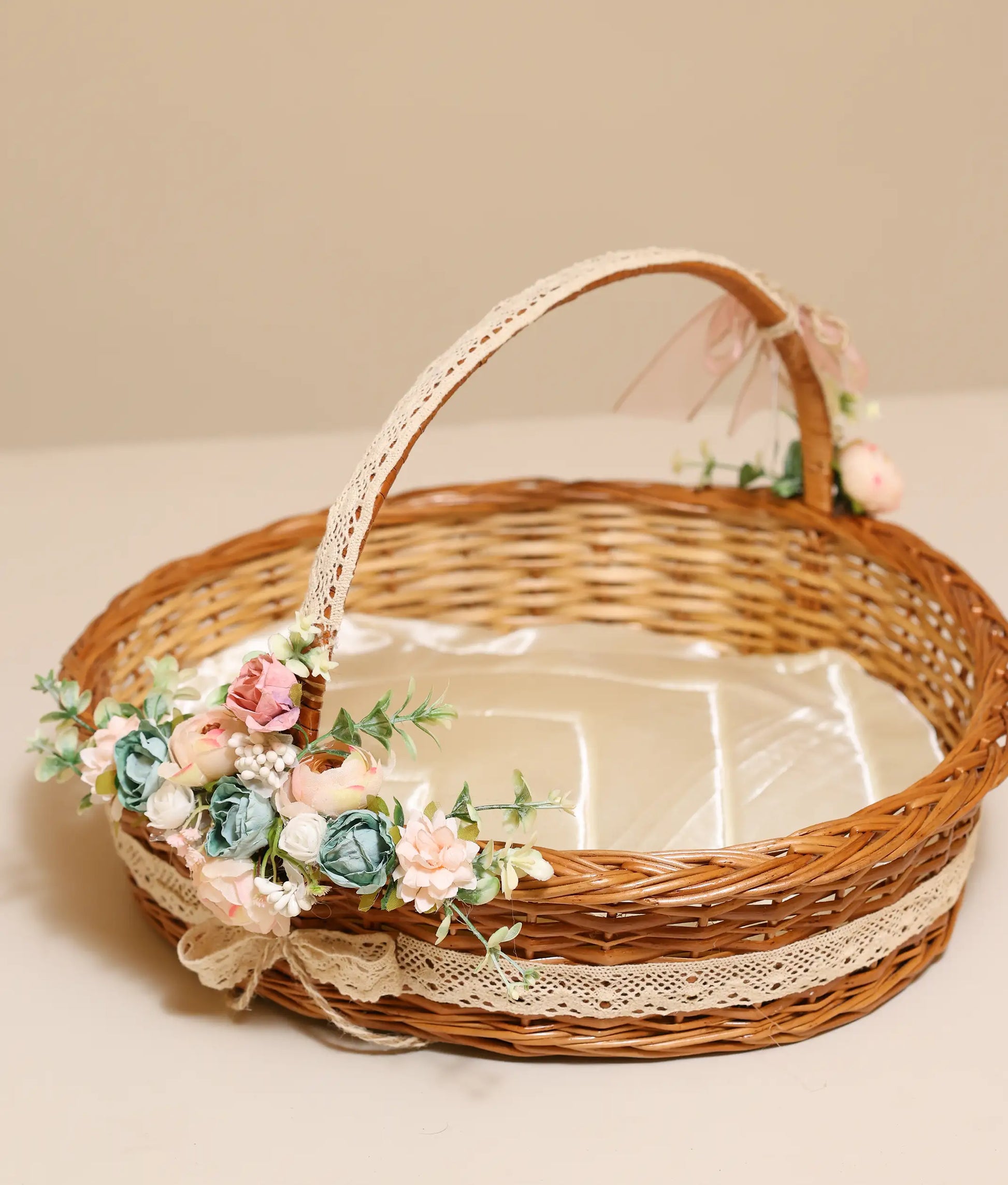 Close view of peach and peacock blue wicker baptism basket against plain background